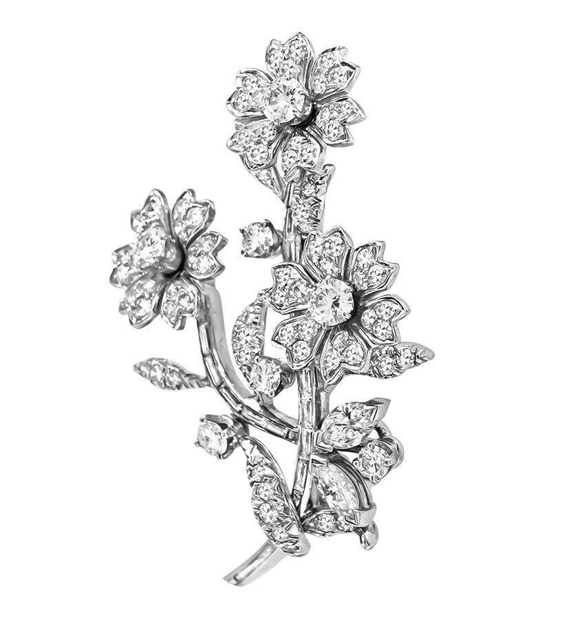 This is an elegant platinum flower pin from the 1950s. The pin is set with sparkling round and baguette cut diamonds that weigh approximately 1.50ct. The color of the diamonds is G with VS clarity. The pin measures 45mm by 28mm and weighs 12.4 grams.