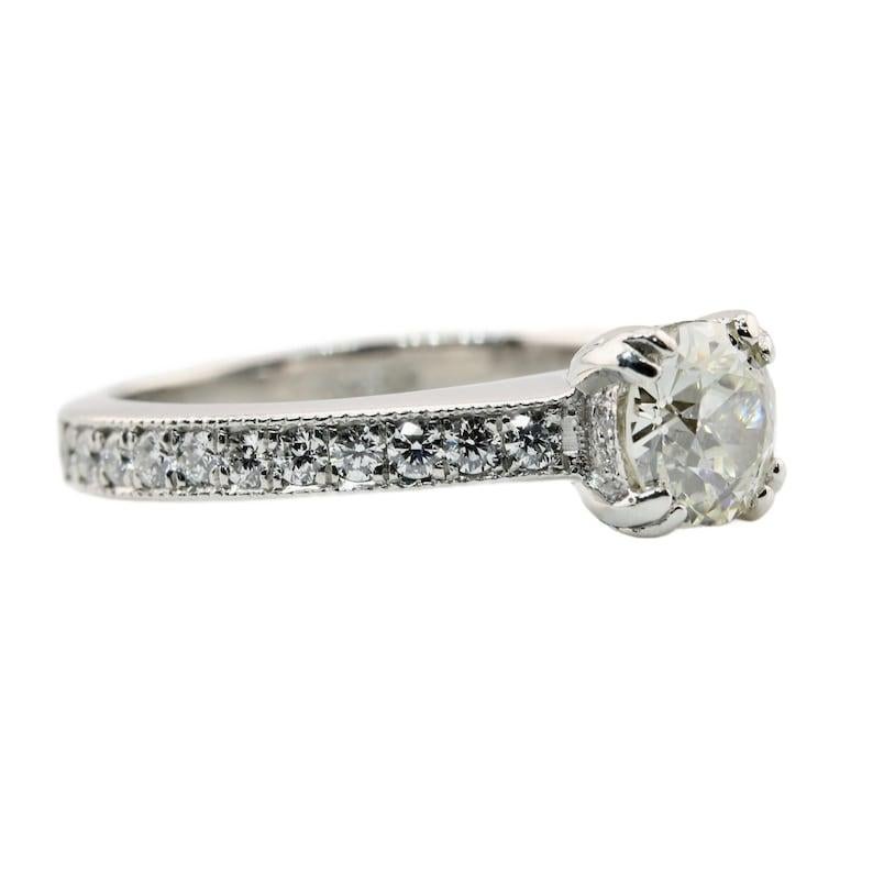 Aston Estate Jewelry Presents:

A beautiful vintage old European cut diamond engagement ring in platinum. Grading as I color and VS2 clarity, the center old European cut diamond sits secured by four claw style prongs.

Accenting this ring are a