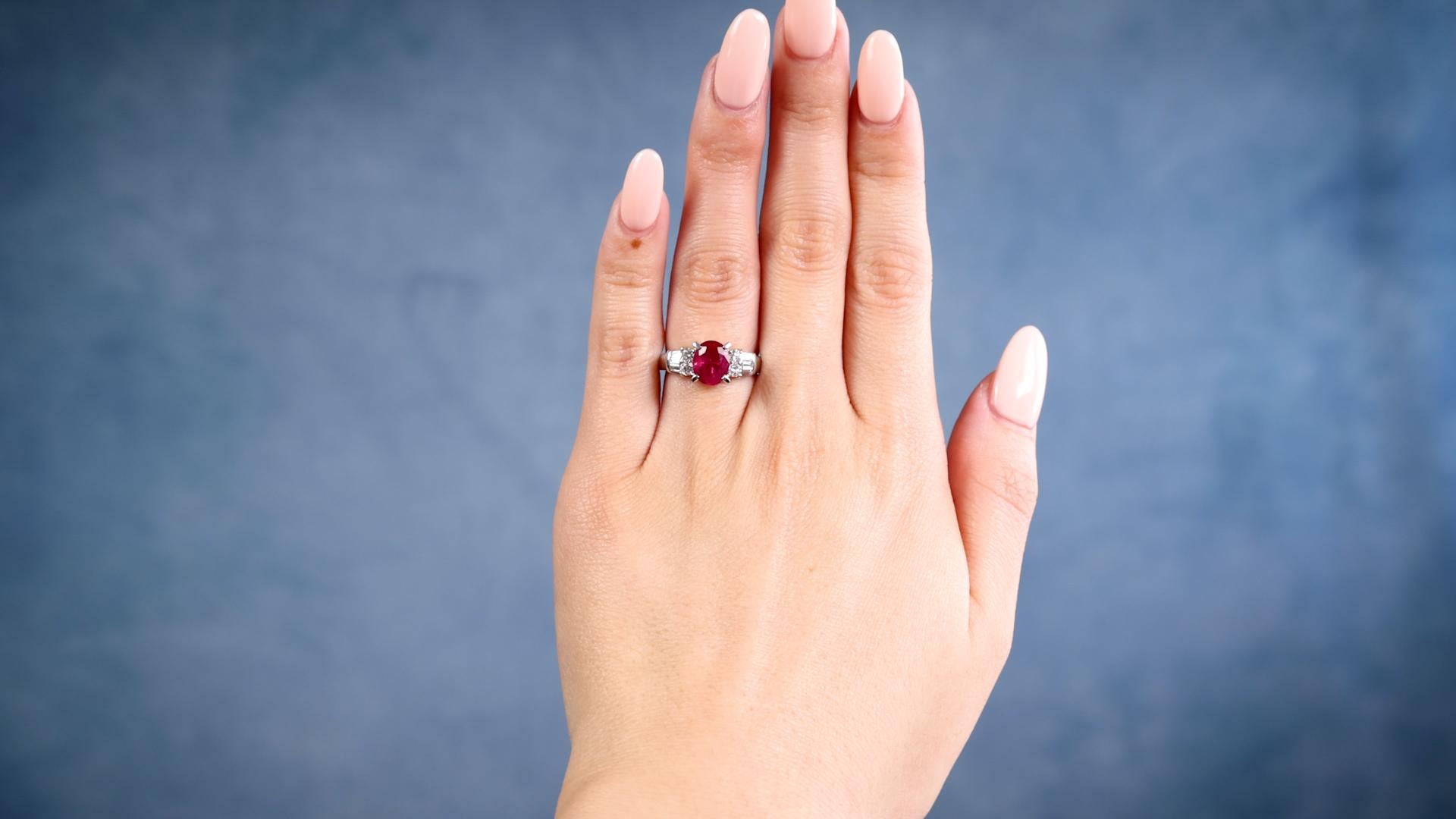 One Vintage 1.54 Carat Ruby Diamond Platinum Ring. Featuring one oval cut ruby of 1.54 carats. Accented by four round brilliant and six tapered baguette cut diamonds with a total weight of 0.38 carat, graded F-G color, VS clarity. Crafted in