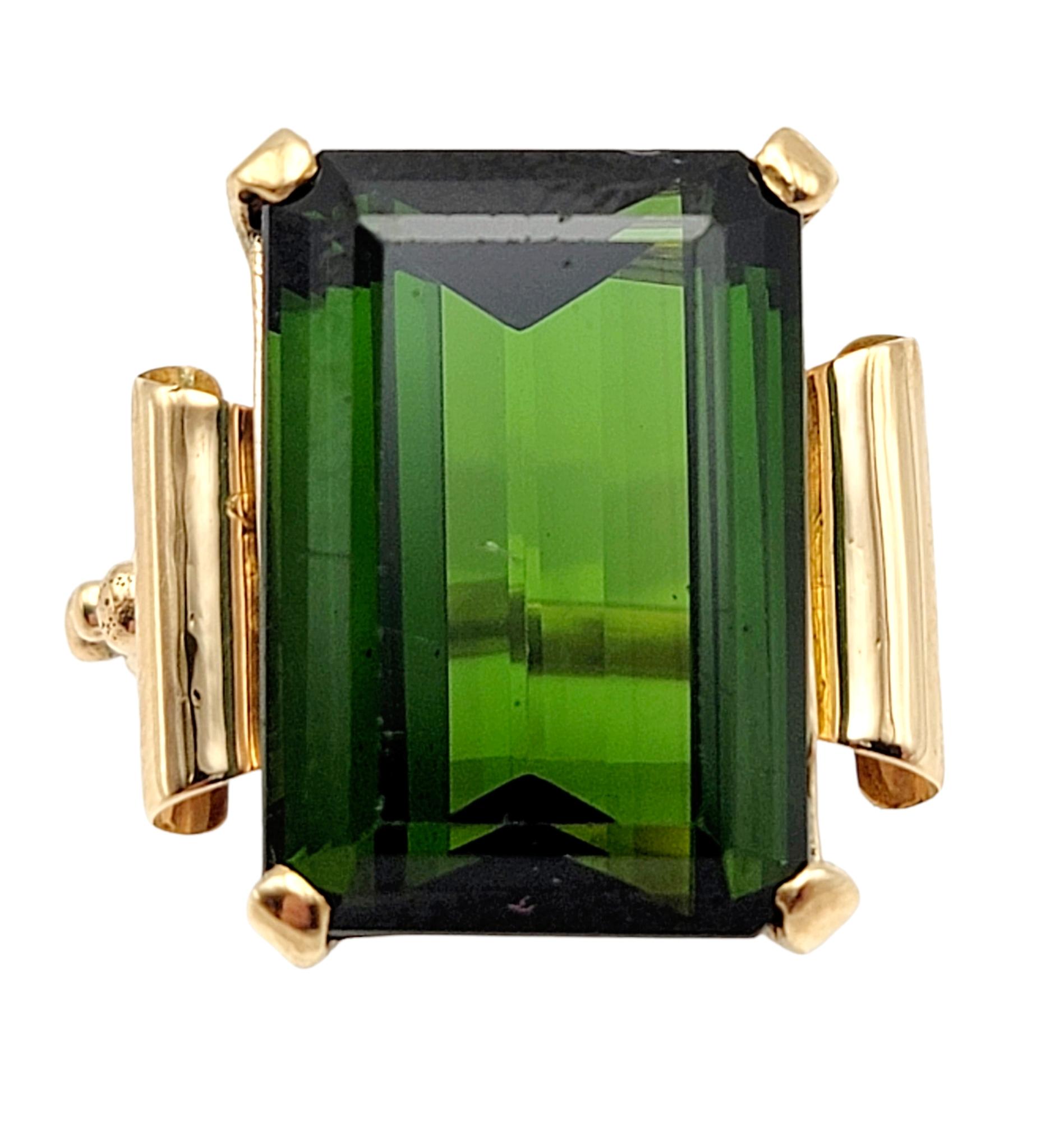 Ring size: 5.25

Amazingly gorgeous vintage cocktail ring featuring a single green tourmaline stone. This eye-catching piece makes a big statement with its impressive size and exquisite color. The huge 15.58 carat emerald cut solitaire tourmaline