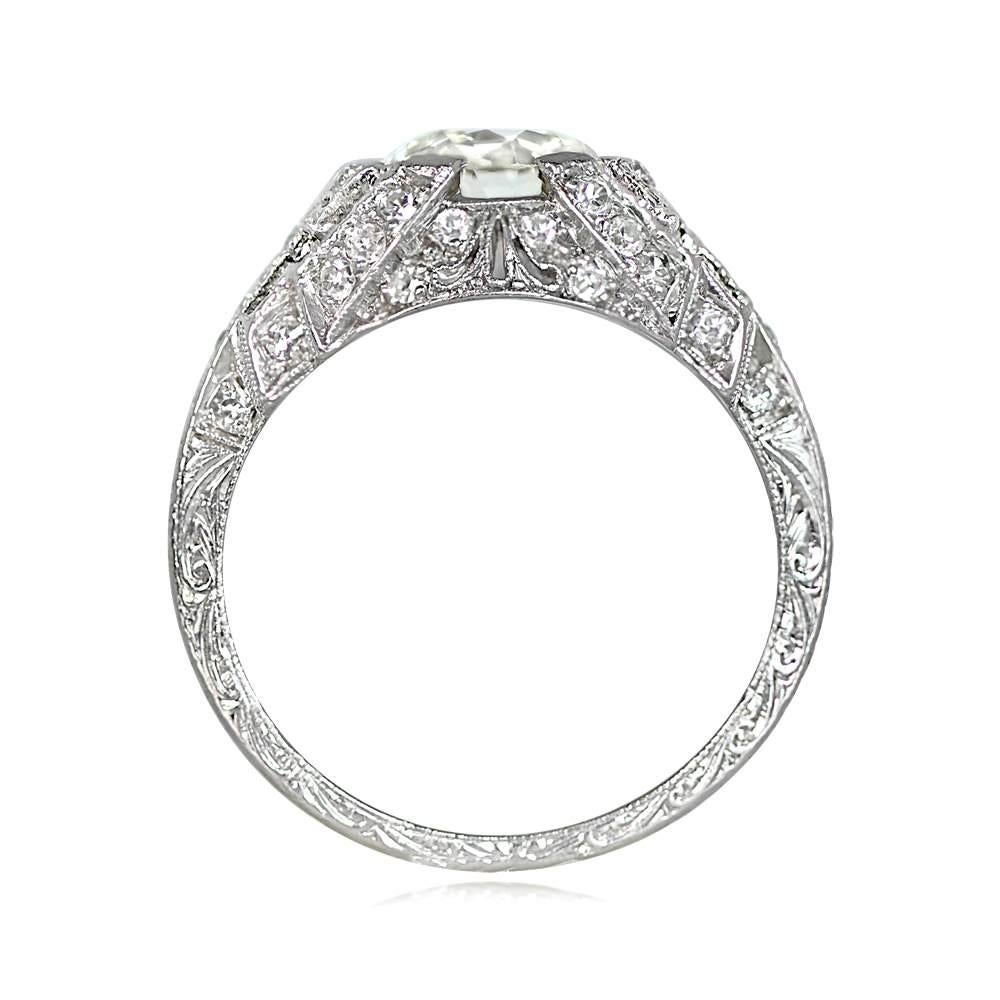 Behold the exquisite allure of an Art Deco masterpiece—a resplendent ring that captivates the beholder with its timeless elegance. Gracing its center is a mesmerizing 1.59-carat old European cut diamond, emanating a warm, beguiling aura with its J