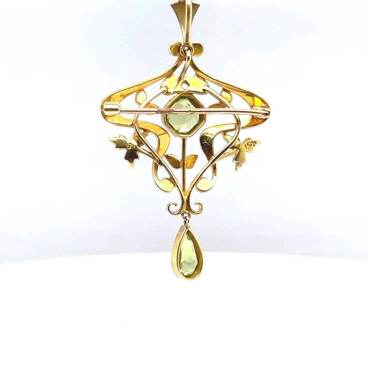 This elegant peridot and seed pearl brooch hails from the Edwardian era, circa 1910, and is a beautiful representation of the period's refined and graceful jewellery design. Crafted from 15-carat yellow gold.
The brooch has two stunning peridots,