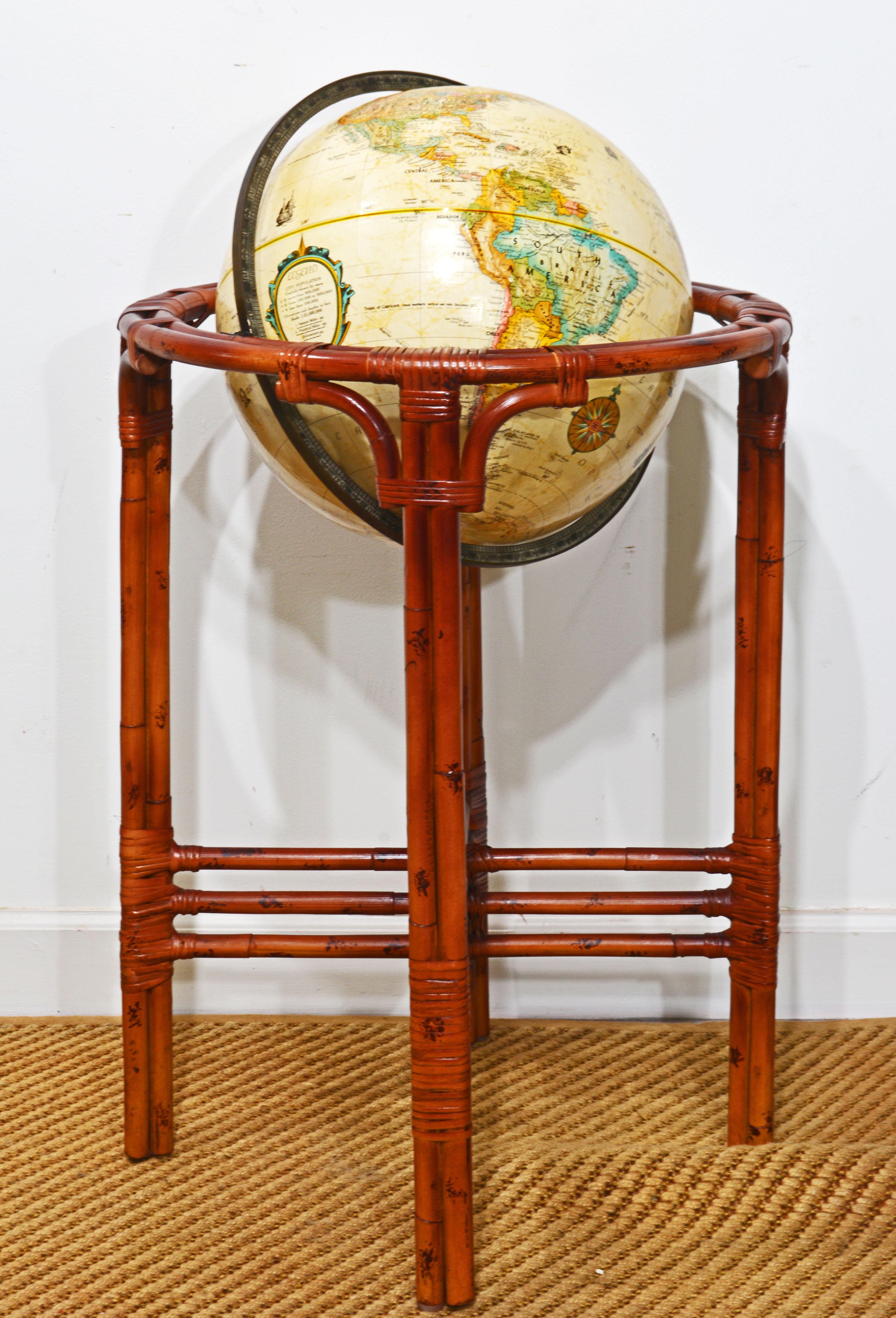This vintage terrestrial Replogle World Classic 16 in. relief globe is mounted in a lacquered Rattan Bamboo stand with four legs, each made of three stems and joined by decorative triple cross stretchers. It is of quite unique tropical colonial