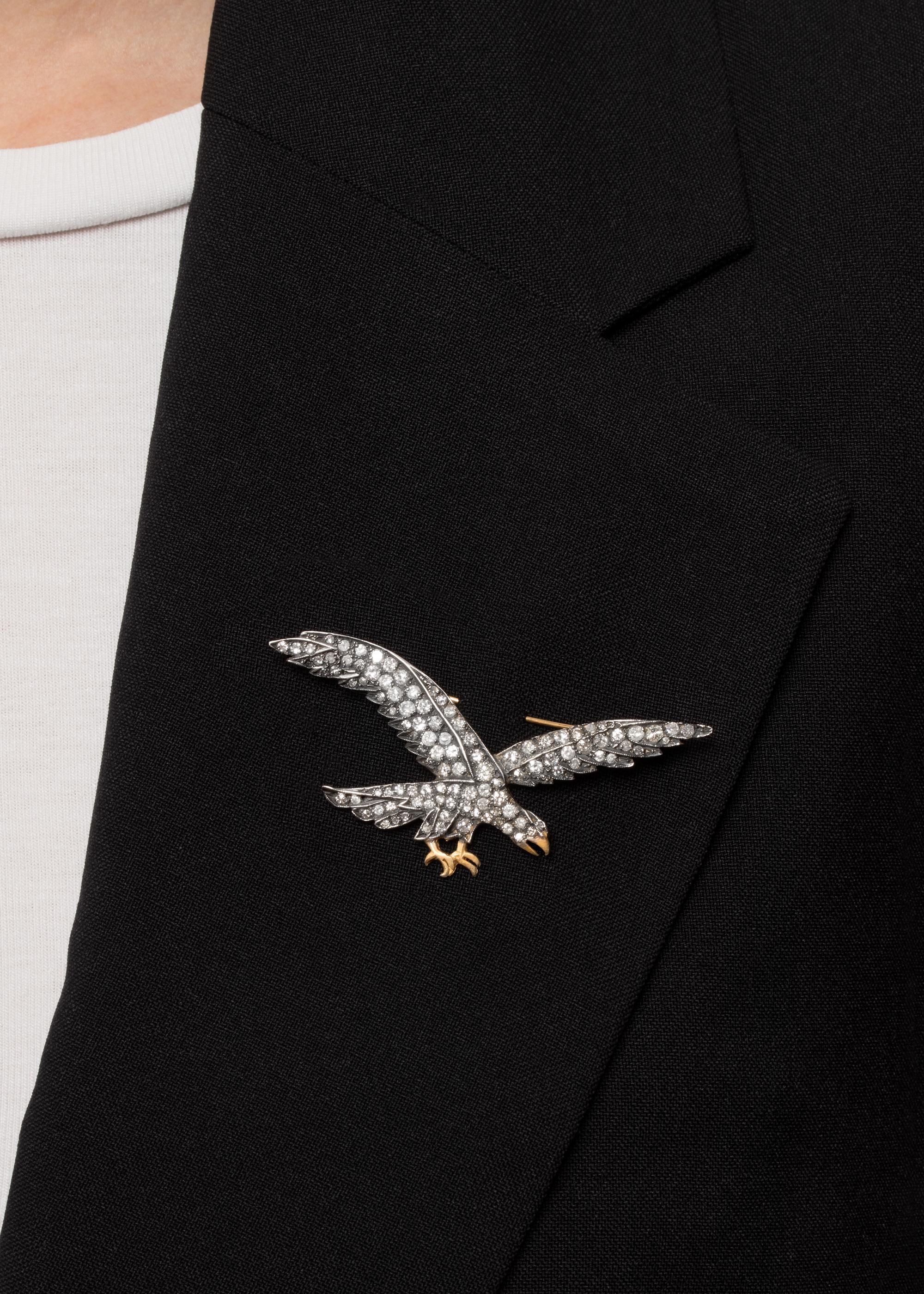 This vintage eagle brooch takes on the likeness of a majestic eagle in flight. The piece is silver fronted and adorned with an assortment of grain set diamonds. Both round brilliant cut and eight cut stones are used totalling 1.60 carats. The