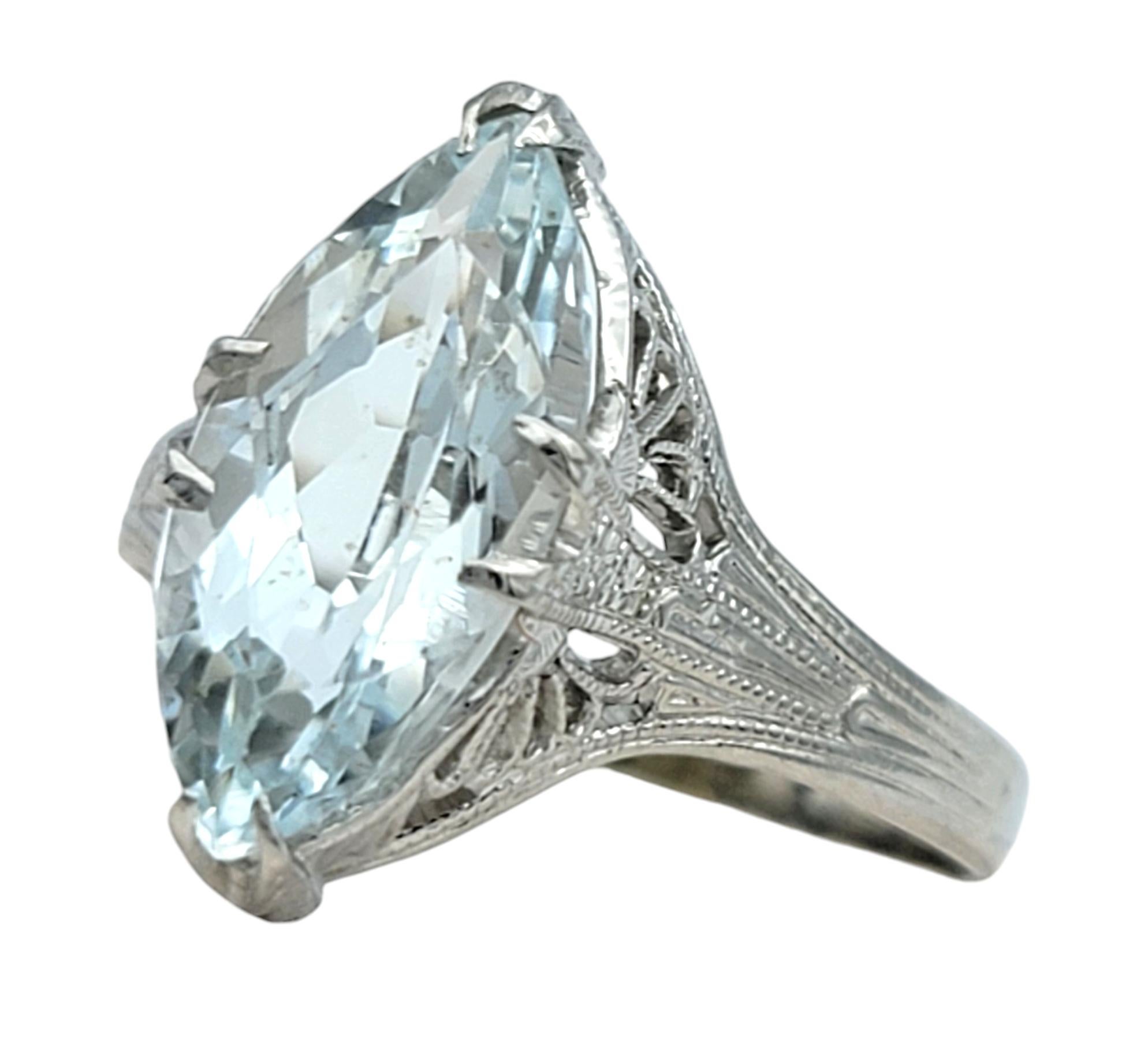Ring Size: 5 

Discover a timeless elegance in this vintage solitaire ring, centered around a captivating marquise cut aquamarine that catches the light with every glance. This stunning stone, with its entrancing shade of serene blue, is artfully