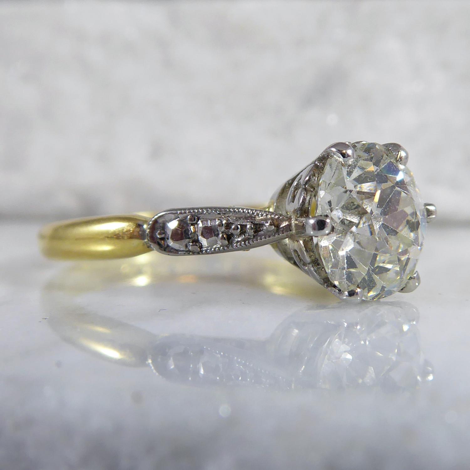 A vintage diamond single stone engagement ring set with an old European cut diamond 1.70ct and with colour and clarity assessed as J and SI2.  The diamond measures approx.  7.36mm x 7.35mm x 4.89mm deep and is set in a white six claw rex setting. 