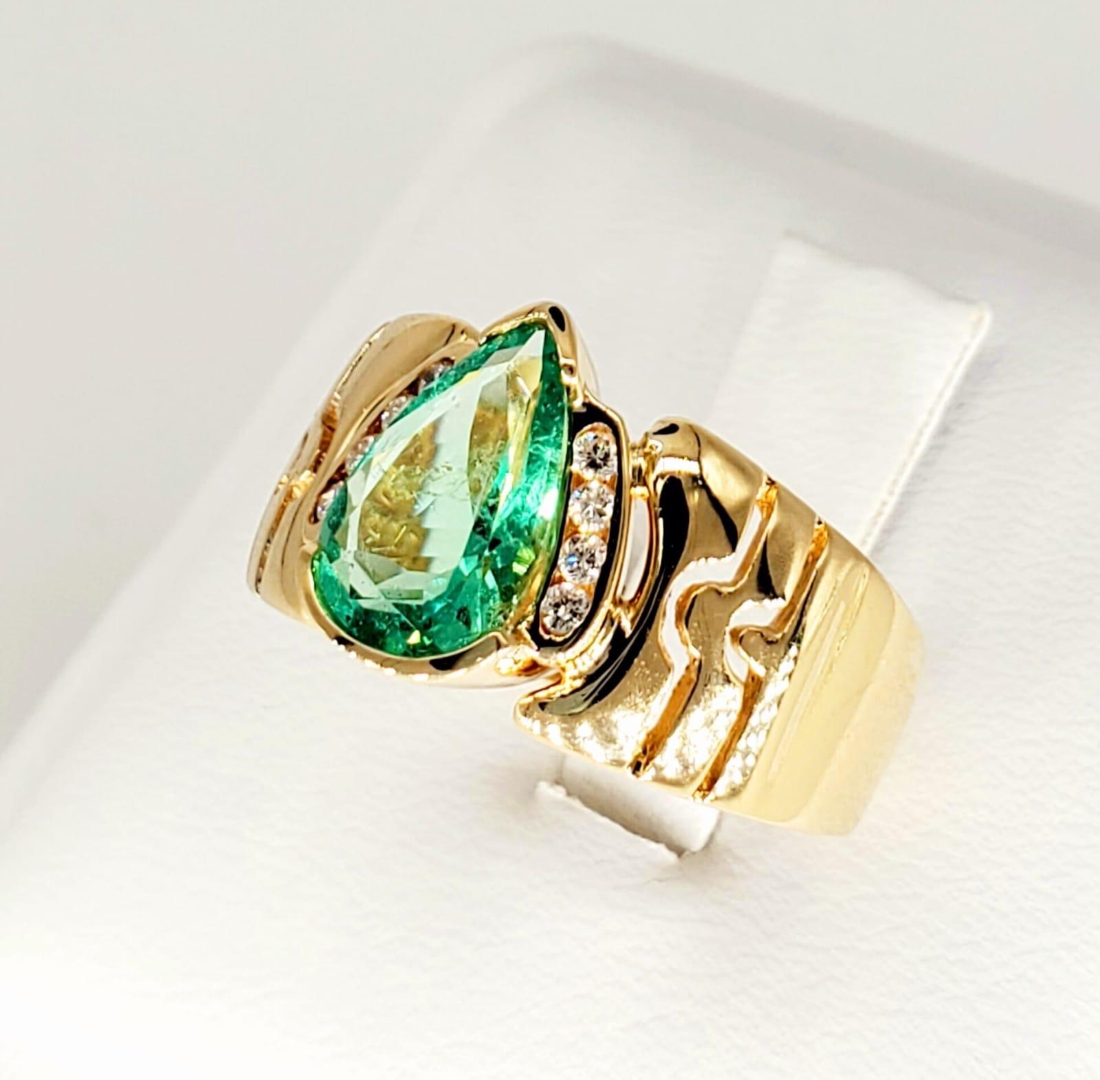Vintage 1.75 Carat Colombian Emerald Cocktail Ring. The ring features a beautiful transparent pear shape Colombian emerald weighing 1.60 carat and surrounding diamonds weighting approx 0.15 carats. The ring is a size 8 and weights 8.1 grams solid