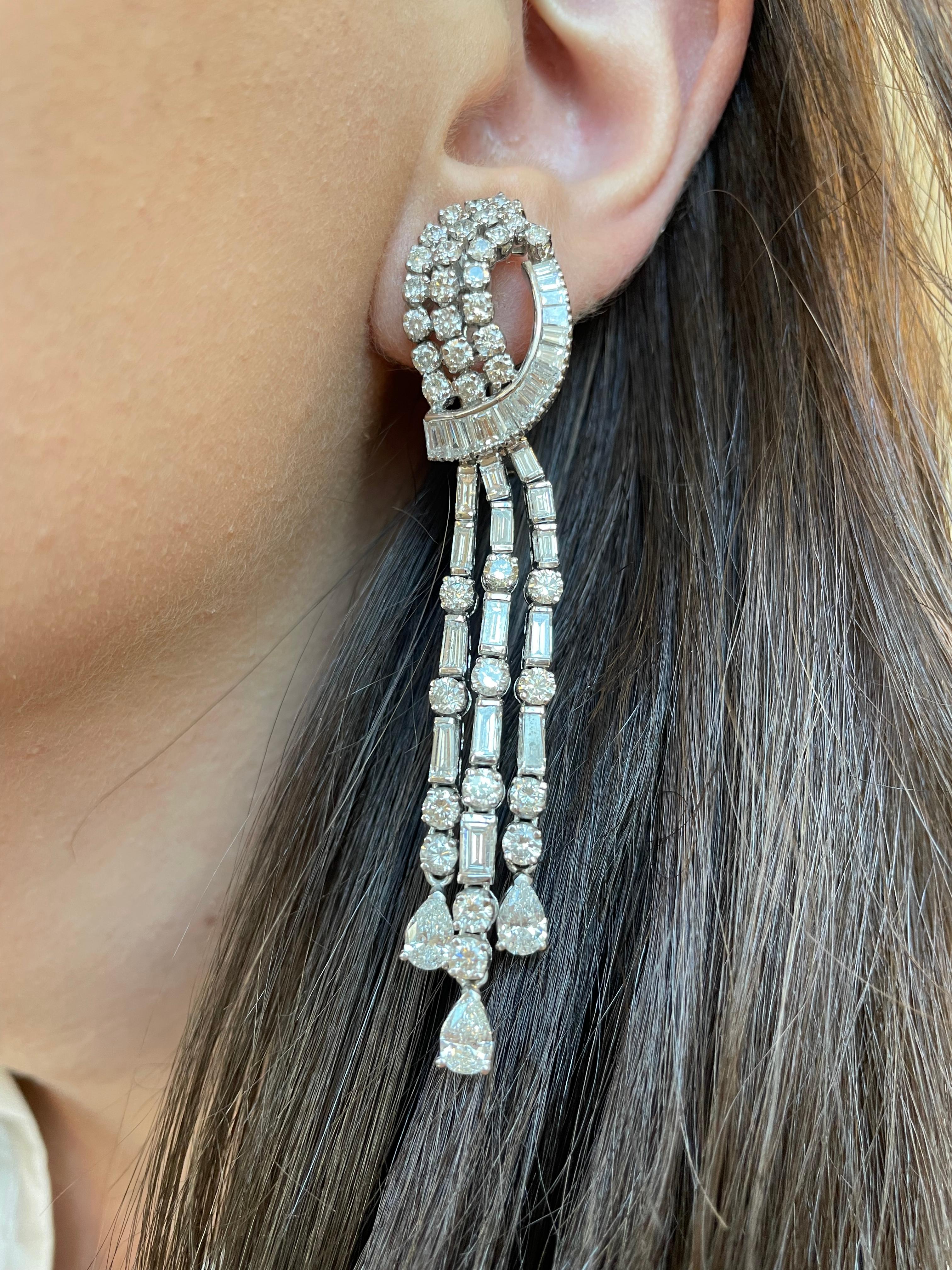 Stunning vintage chandelier high jewelry earrings.
Approximately 17.50 carats of pear, baguette and round brilliant diamonds. Approximately G/H color grade and VS-SI clarity grade. White gold, 3 inches. 
Accommodated with an up-to-date appraisal by