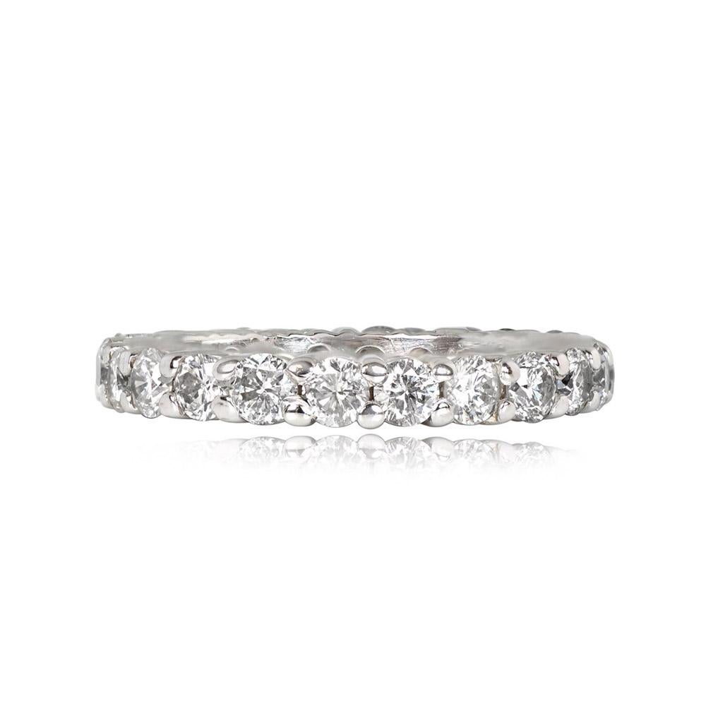 An exquisite vintage diamond eternity band crafted circa 1975 in white gold. This timeless piece showcases approximately 1.76 carats of round brilliant cut diamonds, set in a beautiful shared-prong arrangement. The diamonds exhibit I color and