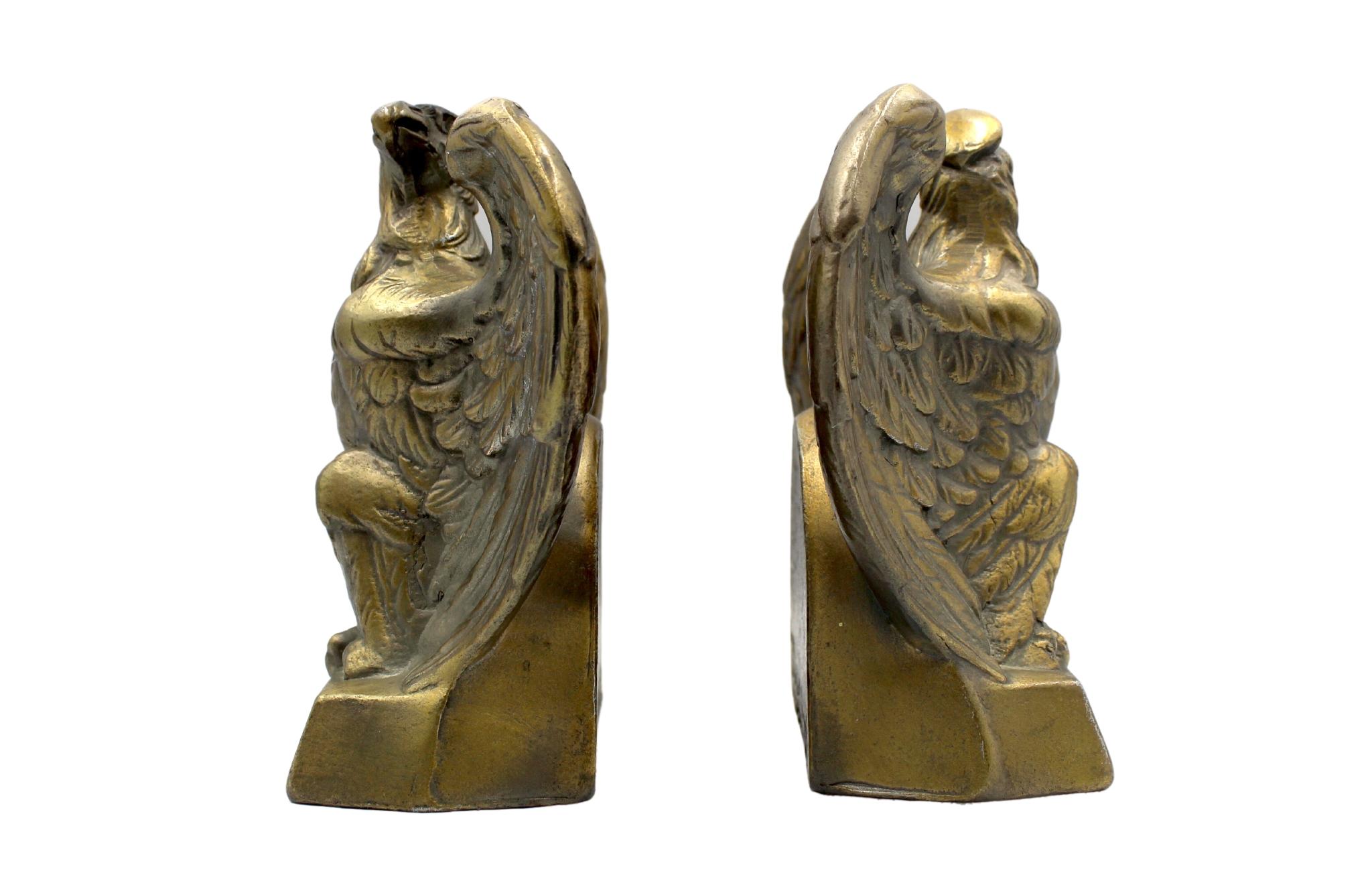 These appealing vintage brass bookends depict a spread-wing bald eagle perched on a rectangular base. The base is stamped with the date “1776.” The bookends were made by Colonial Virginia, a crafter working out of Hampton, Virginia in 1972. The