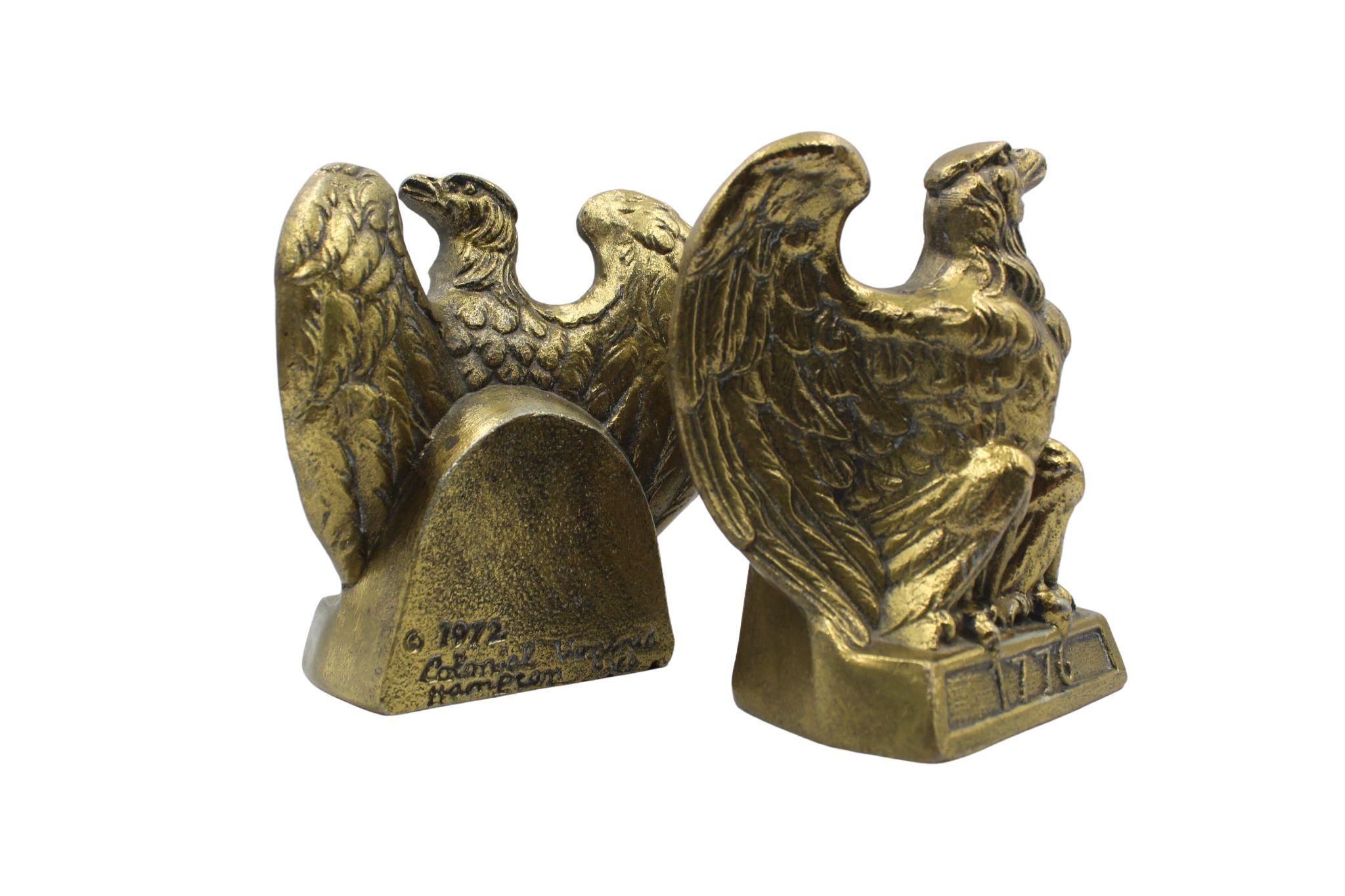 These appealing vintage brass bookends depict a spread-wing bald eagle perched on a rectangular base. The base is stamped with the date “1776.” The bookends were made by Colonial Virginia, a crafter working out of Hampton, Virginia in 1972. The