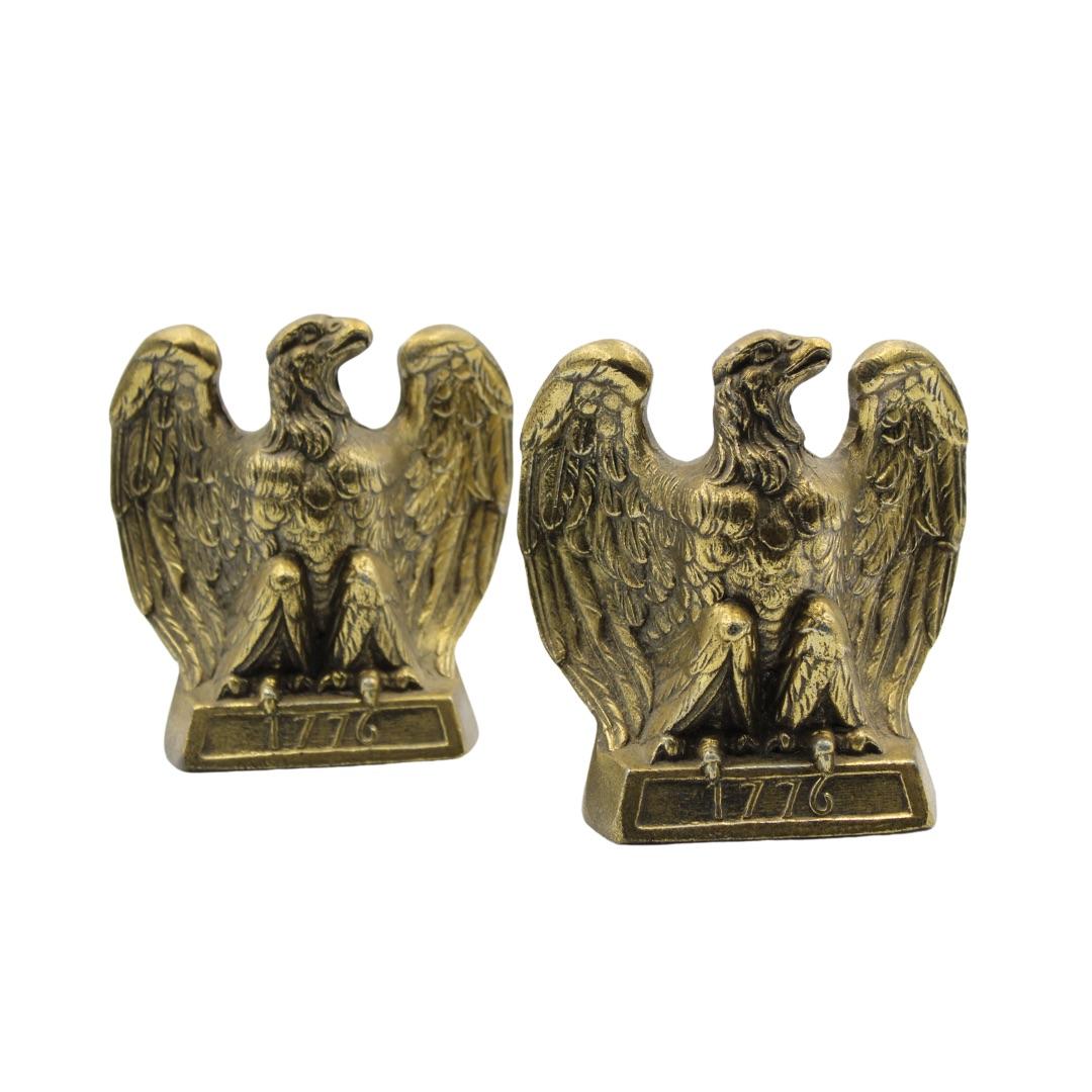 These appealing vintage brass bookends depict a spread-wing bald eagle perched on a rectangular base. The base is stamped with the date “1776.” The bookends were made by Colonial Virginia, a crafter working out of Hampton, Virginia in 1972. The