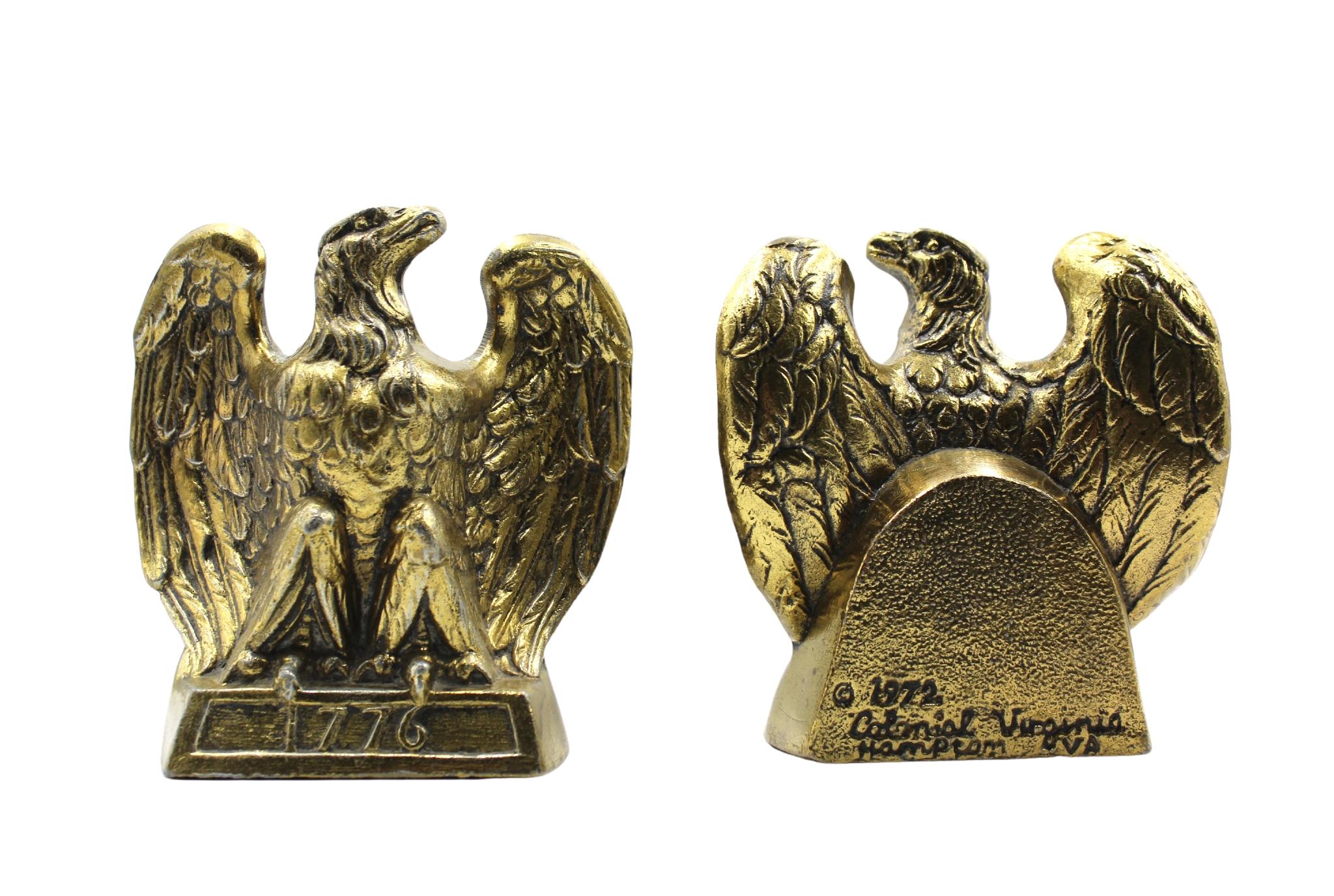 This is an appealing set of vintage brass bookends. The bookends each depict a spread-wing bald eagle perched on a rectangular base, stamped with the date “1776.” The bookends were made by Colonial Virginia, a crafter working out of Hampton,