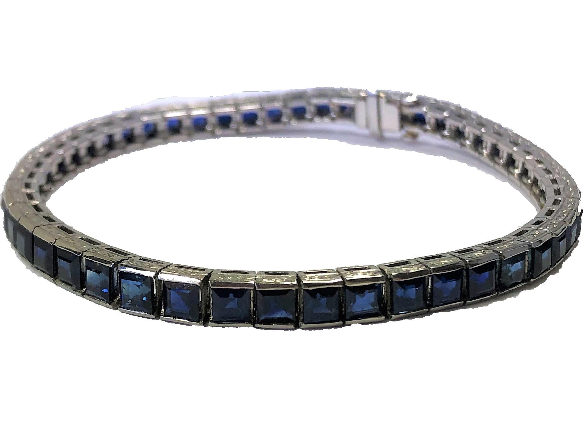 Made of individual platinum blocks set with square cut natural sapphires,
this vintage straight line bracelet has the extra detail of hand engraving on the walls of each block. The deep, rich blue color stands strong against the platinum setting.
