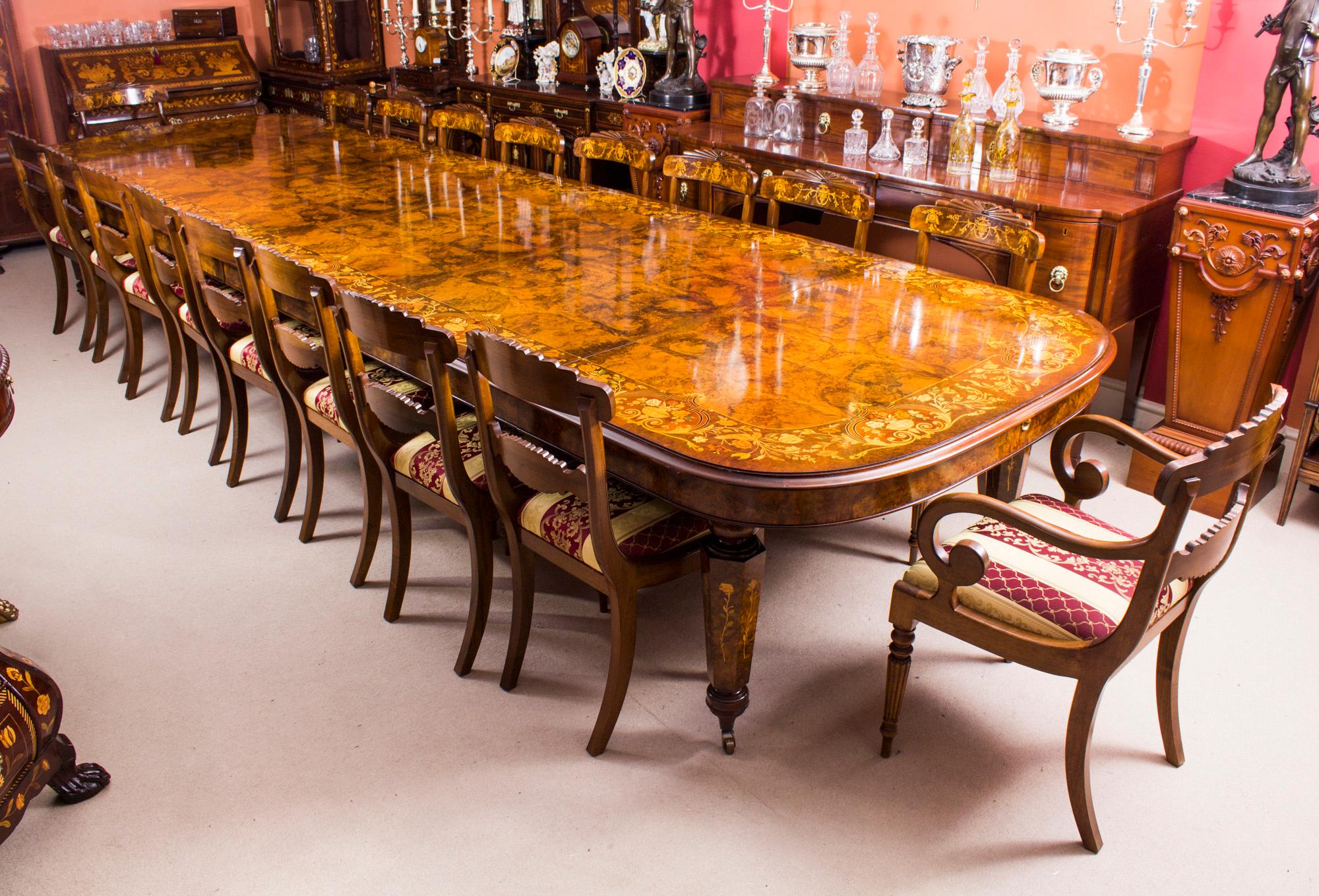 This is a fantastic Vintage Victorian Revival marquetry dining set, comprising a gorgeous burr walnut and marquetry D-End dining room table with the matching set of eighteen chairs, dating from the late 20th century.
The table is made from burr