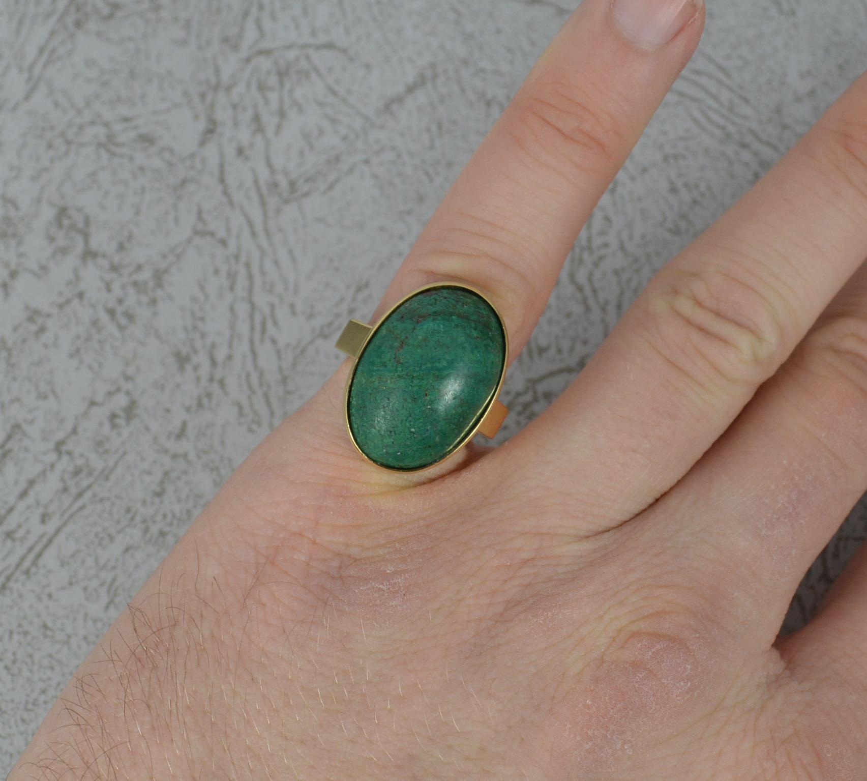 A superb Malachite ring in 18 carat gold.
14ct yellow gold shank and setting.
Designed with a large malachite to the centre 14mm x 20mm, in bezel setting. Protruding 9mm off the finger.
Solid shank, good gauge, attractive shape.

CONDITION ;