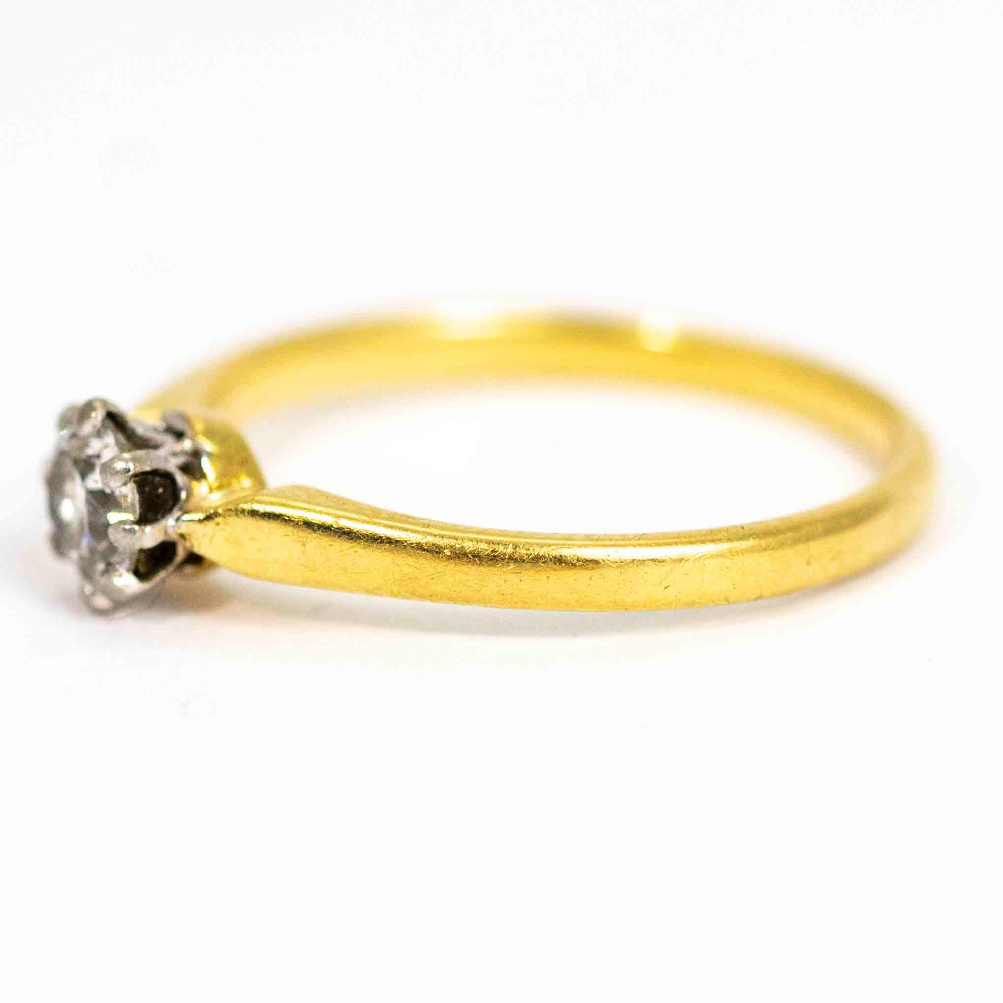 A superb vintage solitaire ring set with a beautiful round cut diamond, measuring approximately 35 points.  The stone sits in a fine platinum claw setting. Modelled in 18 carat yellow gold.

Ring Size: UK N 1/2, US 7
