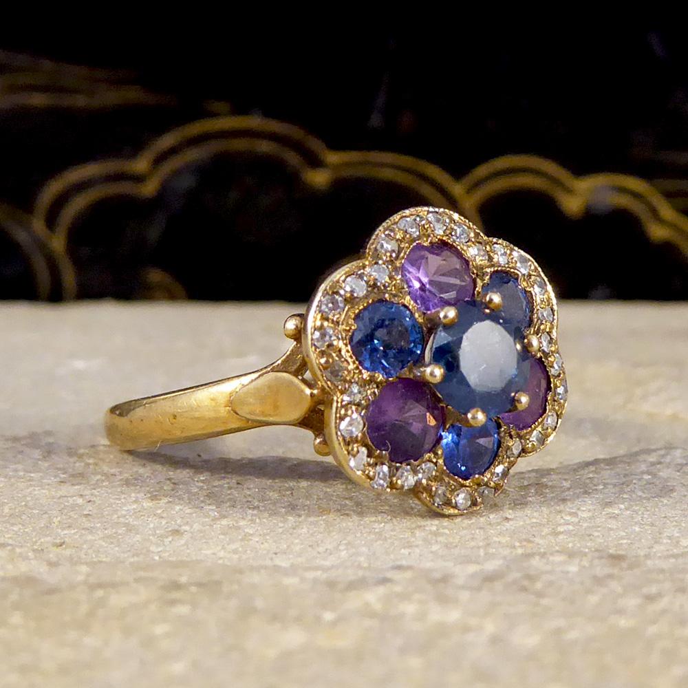Made to give the aesthetic of a flower with alternating blue and purple sapphires, this gorgeous vintage ring has been crafted in unmarked but tested as 18ct Yellow Gold. This ring has a total of 1.25ct Sapphires, alternating from purple to blue