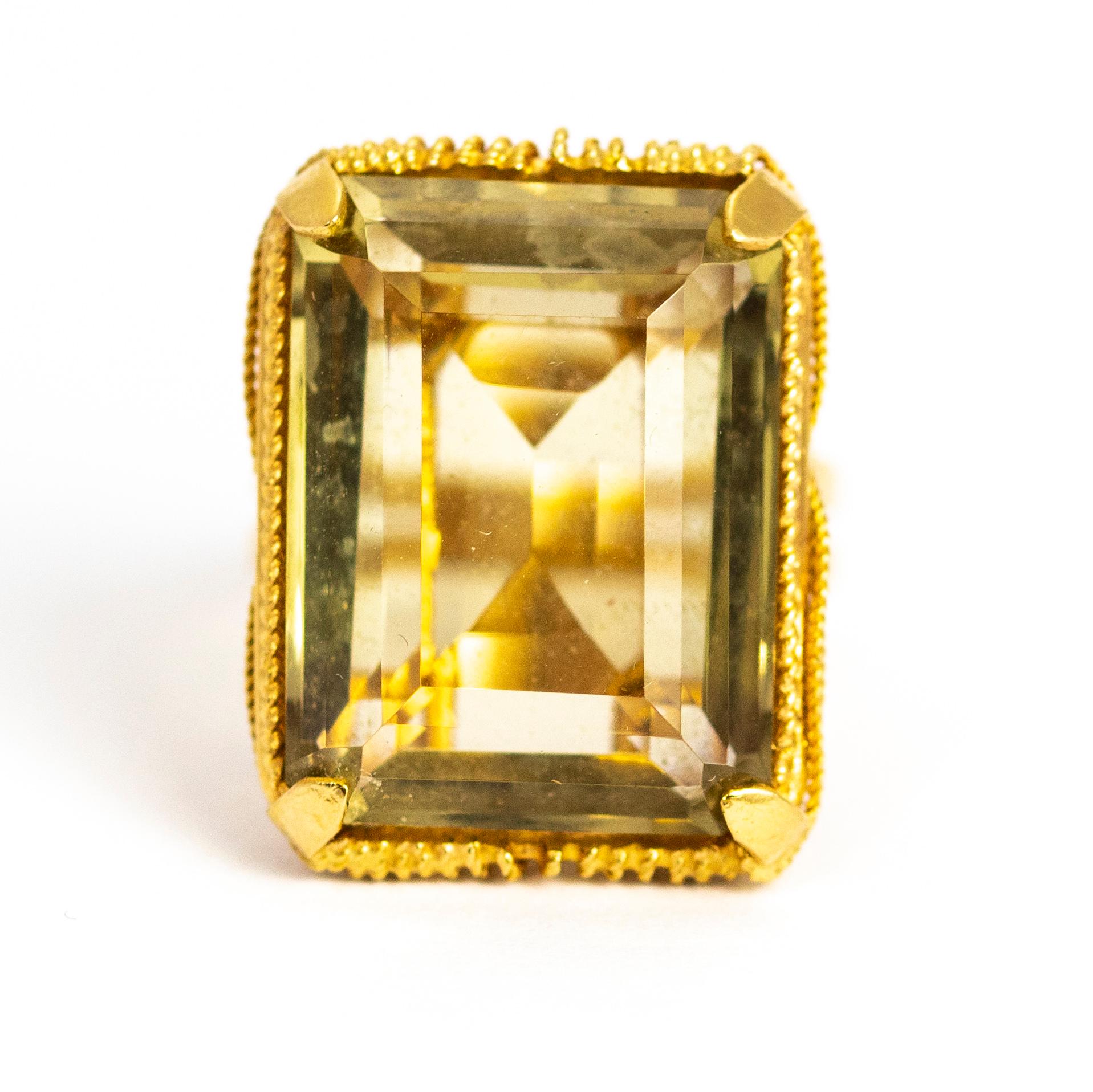 A wonderful vintage cocktail ring set with a beautiful large citrine. The gallery of this ring is set with spectacular rope motifs elegantly draped from the edges of the stone and crossing at the shoulders. The band also has a great split design. 