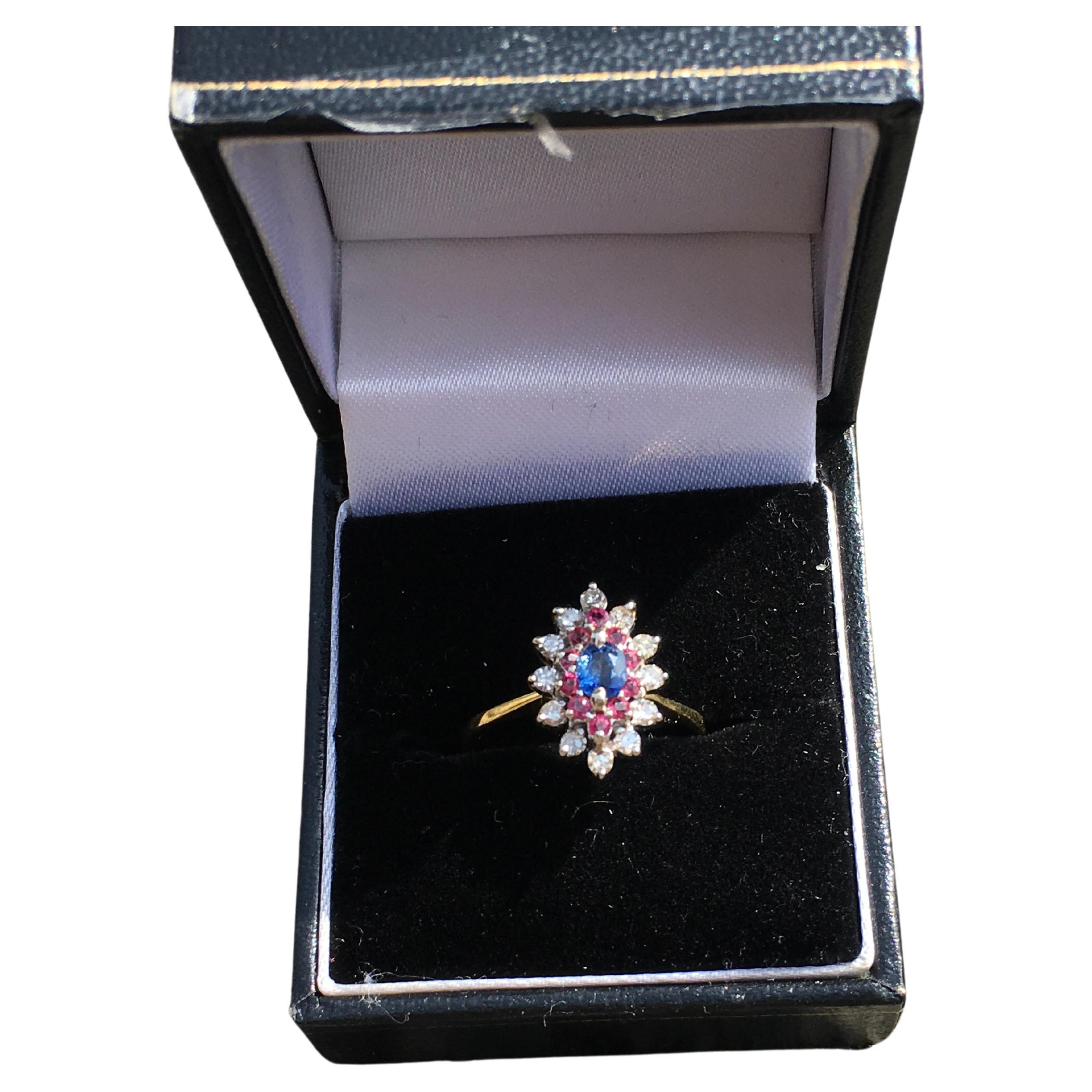 Stunning vintage 18 carat yellow gold marquise ring.
Made in the UK
In very good condition 
Set with a sapphire in the center approx 5 mm x 4 mm
Surrounded by 10 rubies followed by 12 diamonds. 
Ring head measures 1.5 cm long x 1 cm wide.

Weight 3