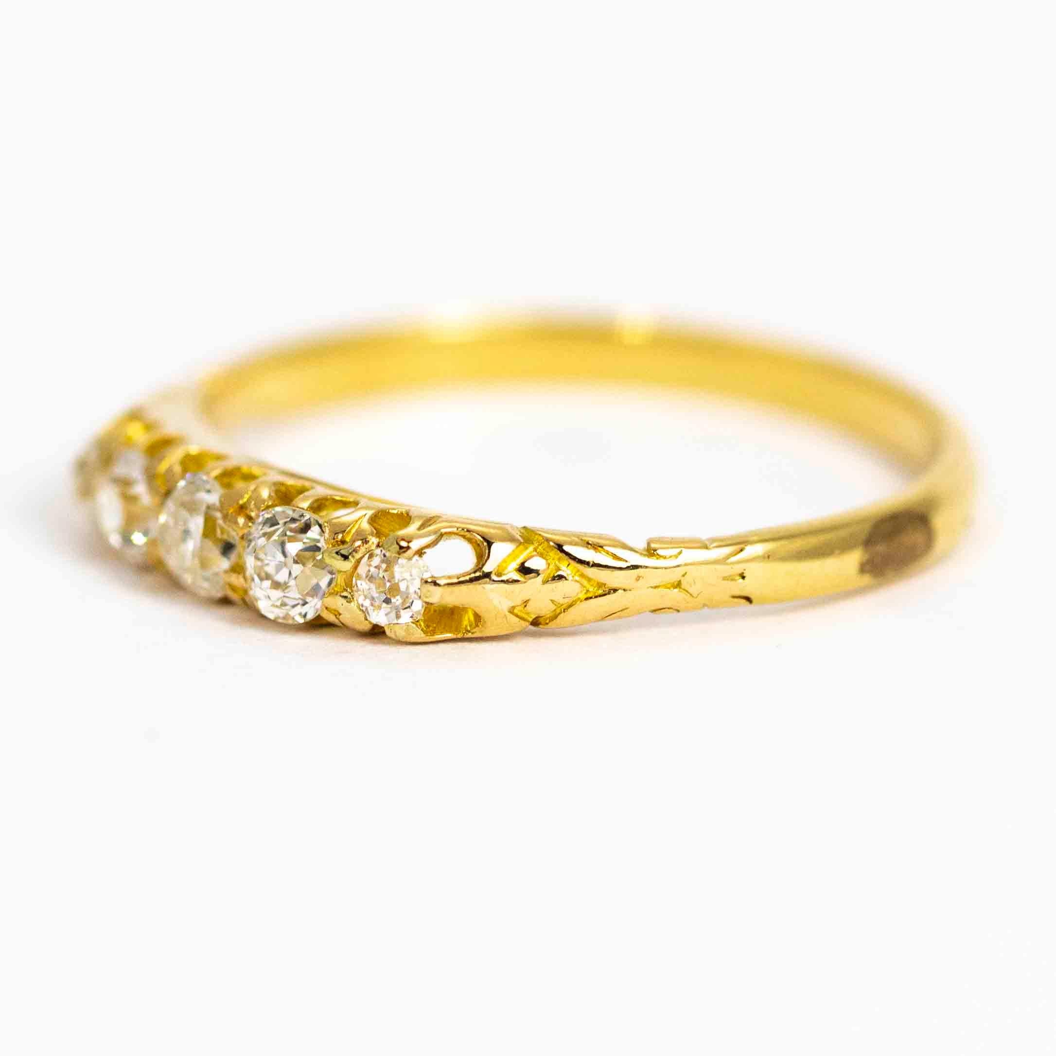 A stunning vintage five-stone ring. The five beautiful cushion cut diamonds are wonderfully bright and graduate in size. The central stone measures approximately 10 points, and the total carat weight in the ring is approximately 0.36cts. The stones