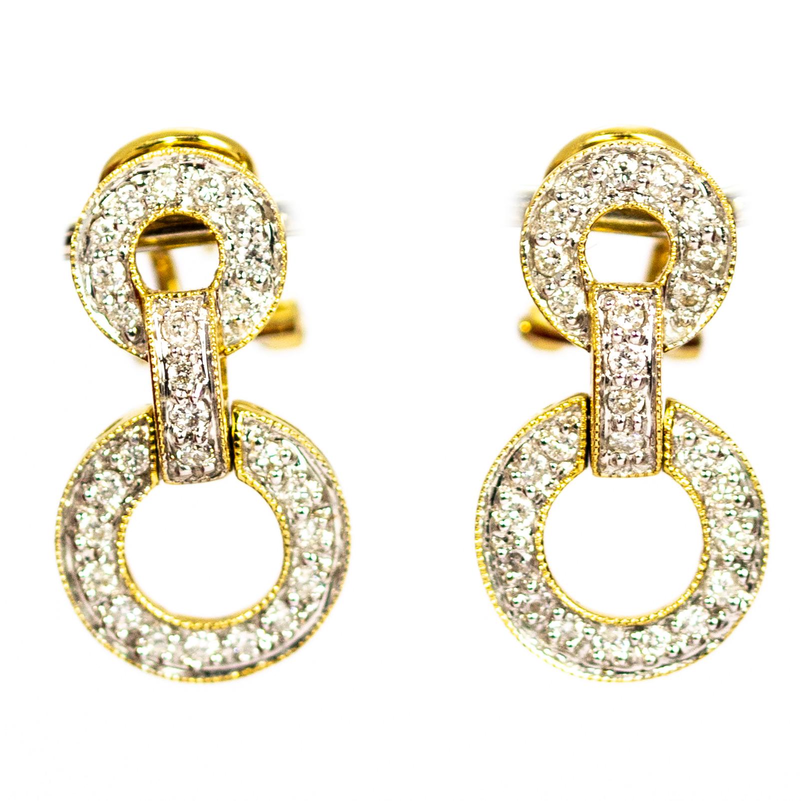 An exquisite pair of vintage earrings. Each is composed of linked circles fully encrusted with 26 stunning round cut white diamonds. The stones are set in white gold to complement their colour. Modelled 18 carat yellow gold with stud clip