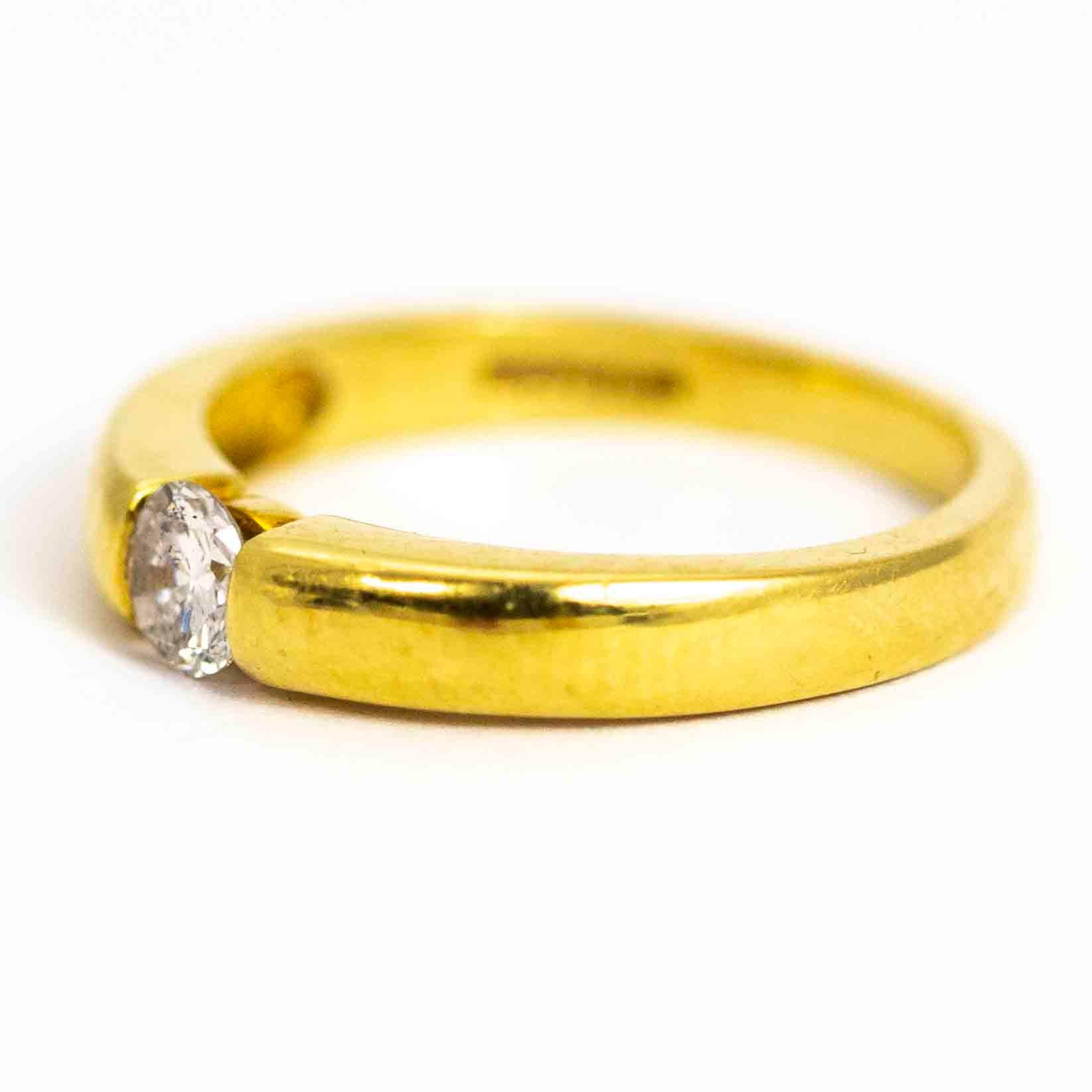 A fine vintage diamond solitaire ring. The round cut diamond is deep set and of wonderful quality, measuring approximately 25 points. Modelled in 18 carat yellow gold.

Ring Size: UK J, US 5 