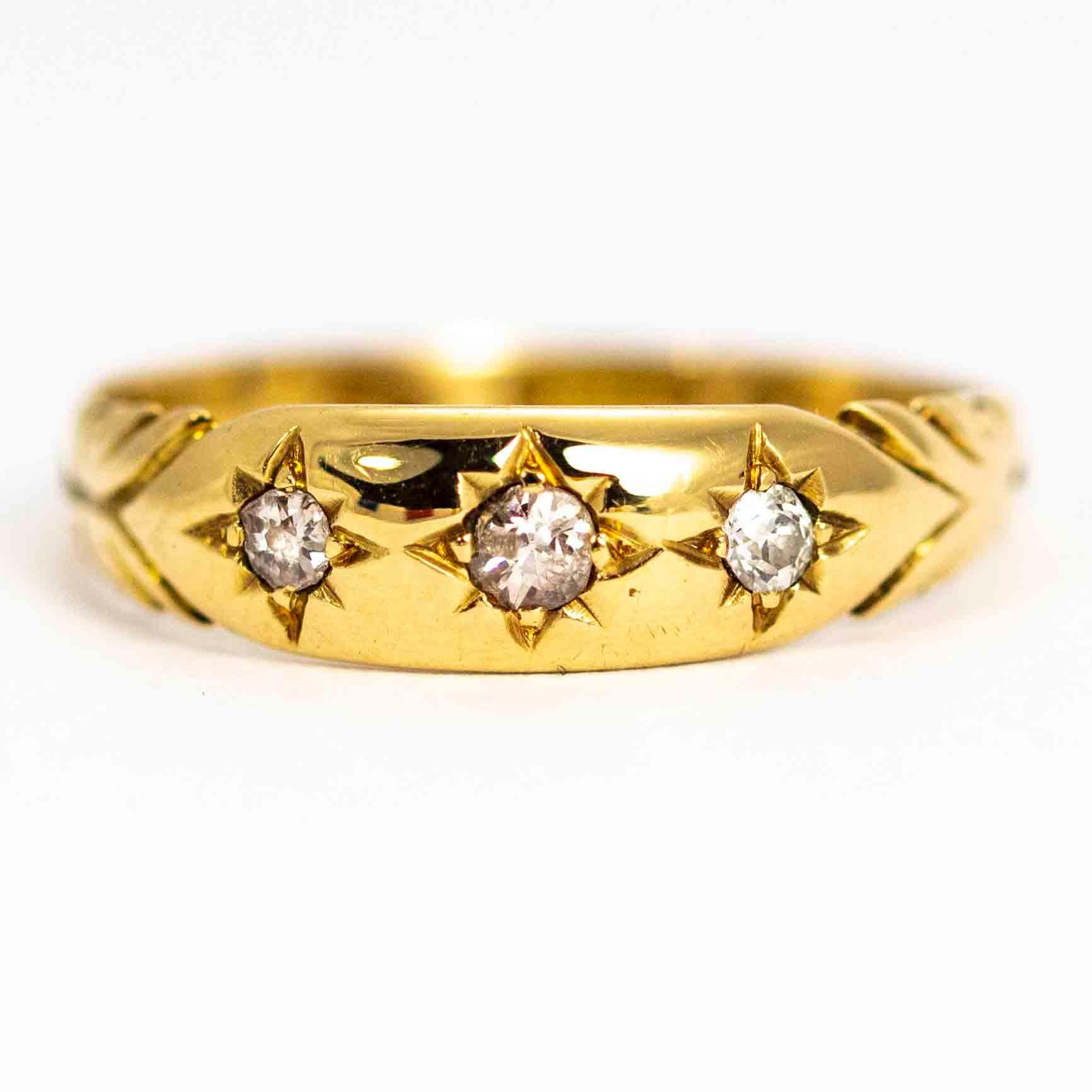 A wonderful vintage gypsy three-stone ring set with 18 points of beautiful white round cut diamonds. The stones sit between fine detailed shoulders. Modelled in 18 carat yellow gold. Fully hallmarked 1965 Chester, England.

Ring Size: UK K 1/2, US 6
