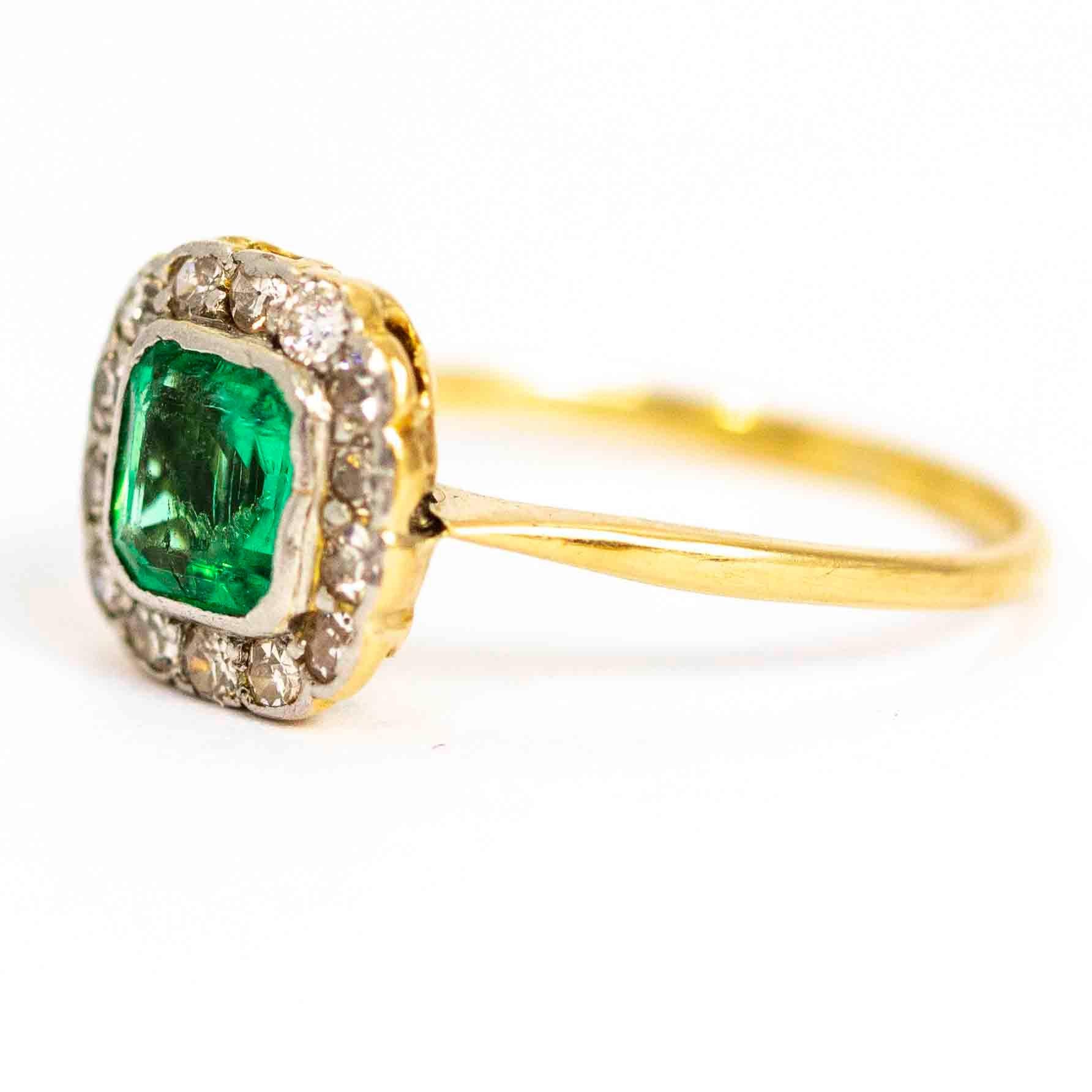 An exquisite vintage cluster ring. Centrally set with a magnificent emerald measuring approximately 90 points, surrounded by a halo of 14 wonderful round cut diamonds. The total diamond weight in this ring is approximately 0.42 carats. Modelled in