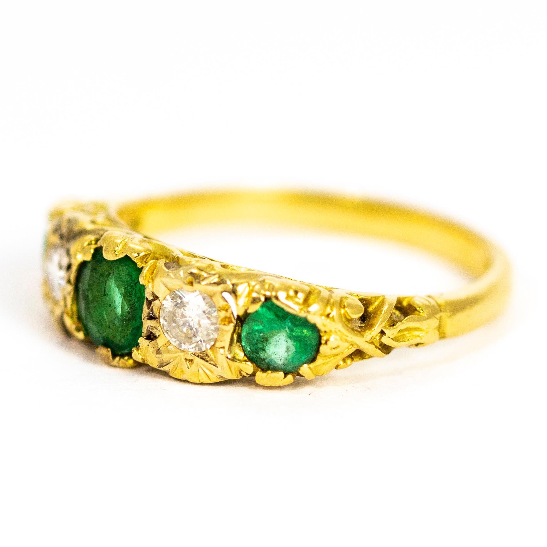 An exquisite vintage five-stone ring set with beautiful alternating emeralds and diamonds. The superb central round-cut emerald measures approximate 60 points. This is flanked by two wonderful brilliant-cut white diamonds measuring approximately 15