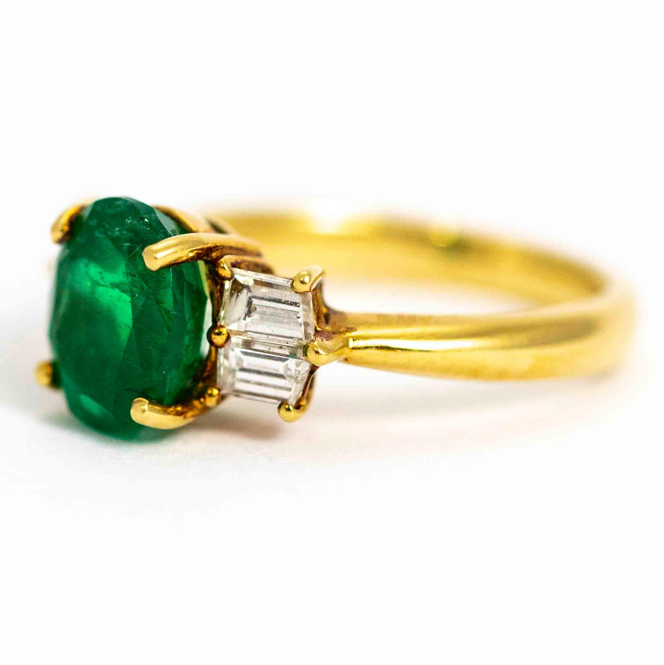 A stunning vintage emerald and diamond ring. Centrally set with a magnificent oval cut green emerald measuring approximately 1.6 carats. Flanking the emerald are four exquisite baguette cut diamonds. Modelled in 18 carat yellow gold.

Ring Size: UK