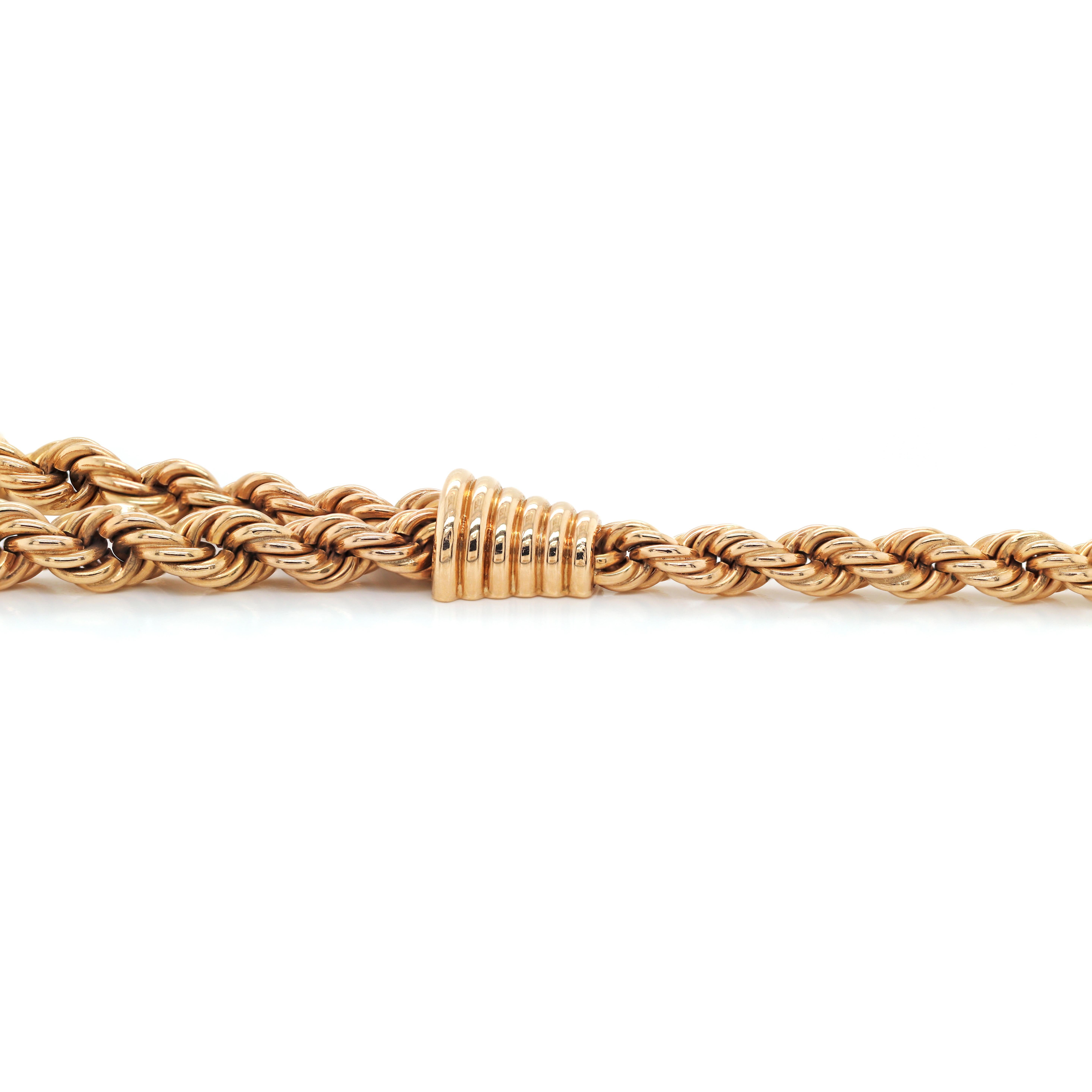 This unusual vintage necklace is a double row, 18 carat rose gold graduated rope chain connected by two ribbed cone design links onto a single rope chain. The necklace is finished with a secure bayonet fastening and safety catch and measures 16.5