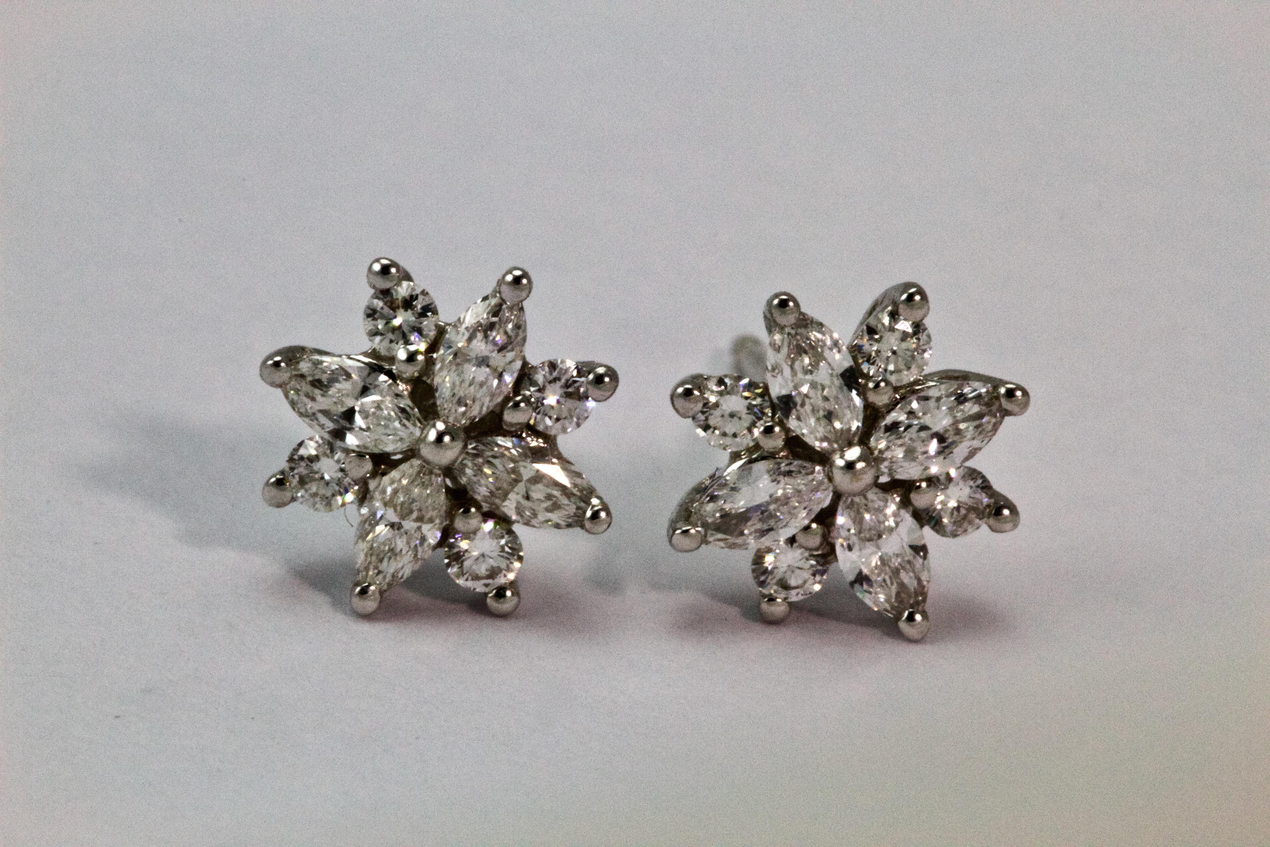 Adorable 18 carat white gold studs, wonderfully modelled as delicate flowers, with marquise shaped diamonds, accented by round brilliant cut diamonds. 

Measurements: approx 8.65mm

Weight: 2.4 grams total