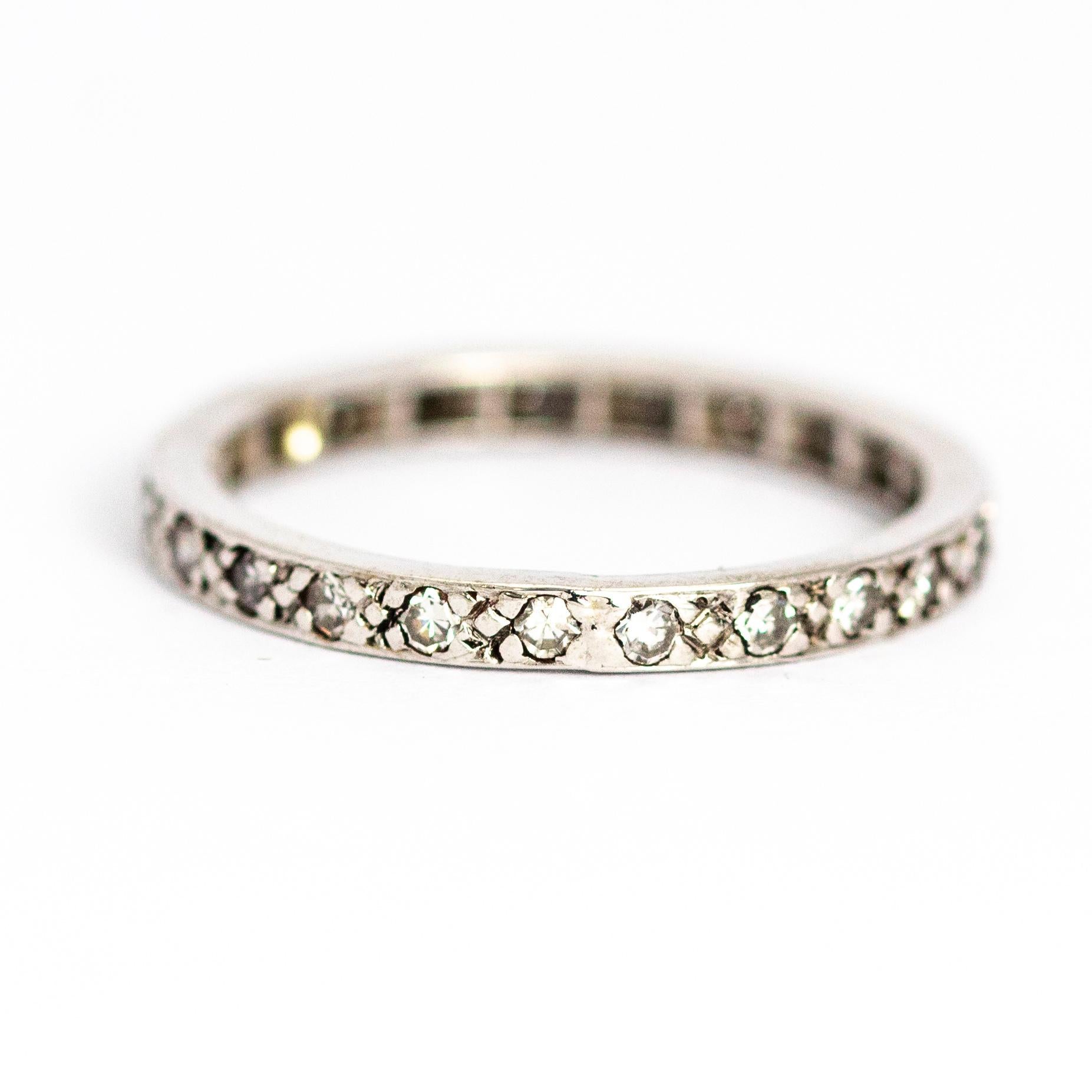 A superb vintage eternity band fully set with 23 wonderful 3 point round-cut white diamonds. Total diamond weight approximately 0.69 carats. Modelled in 18 carat white gold.

Band Width: 2.35mm

Depth to finger: 1.65mm

Ring Size: UK O, US 7