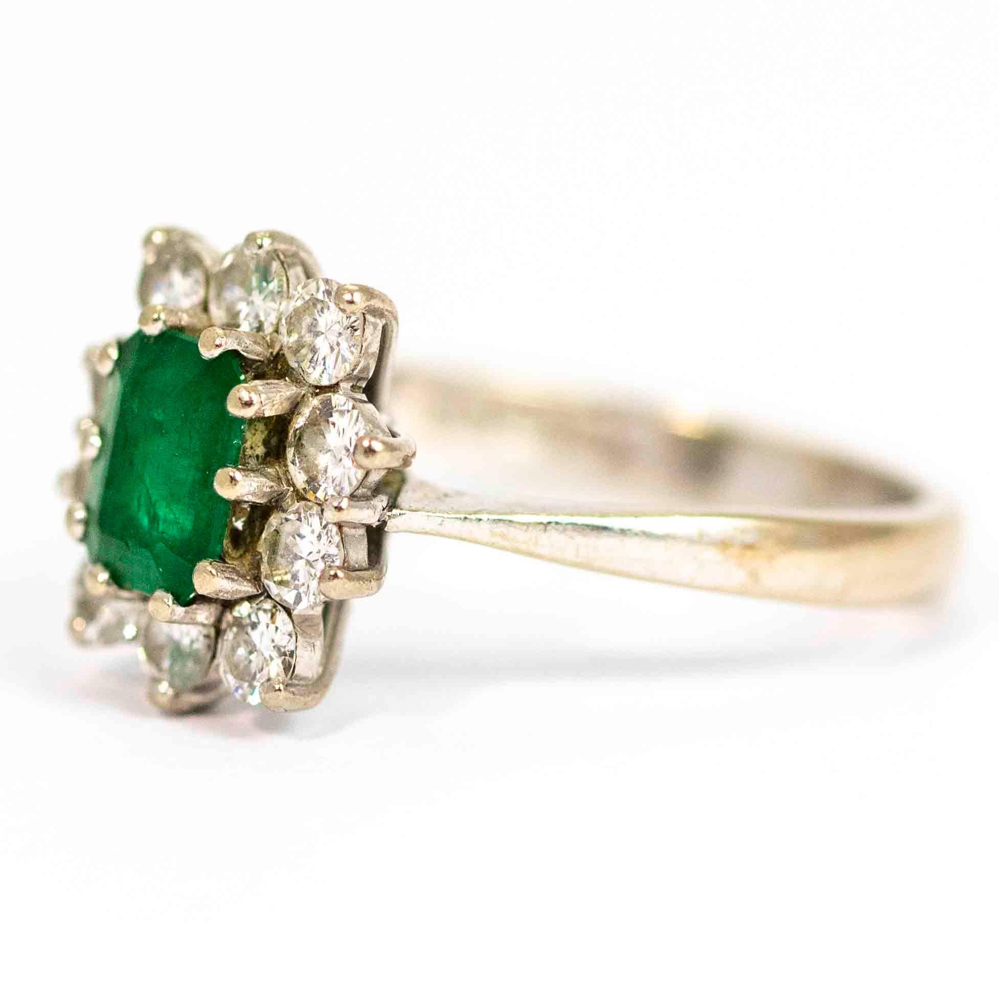 An exquisite vintage rectangle cluster ring. Centrally set with a wonderful green emerald measuring approximately 75 points, surrounded by 10 beautiful round cut diamonds. The total diamond weight in this ring is approximately 50 points. Modelled in