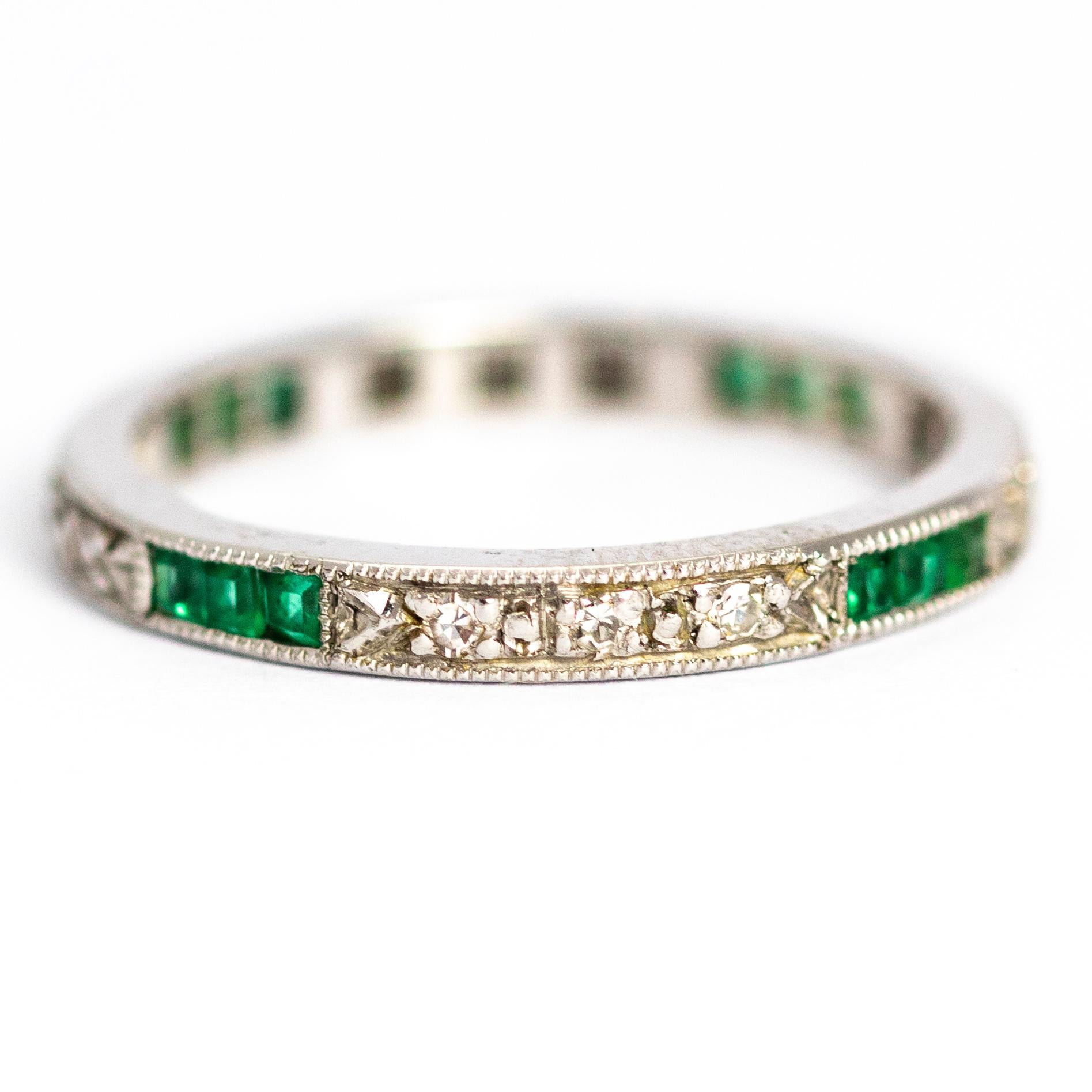 A stunning vintage eternity band ring fully set with emeralds and diamonds. Alternating trios of princess-cut green emeralds are set between trios of round-cut white diamonds all around this wonderful ring. Modelled in 18 carat white gold.

Ring