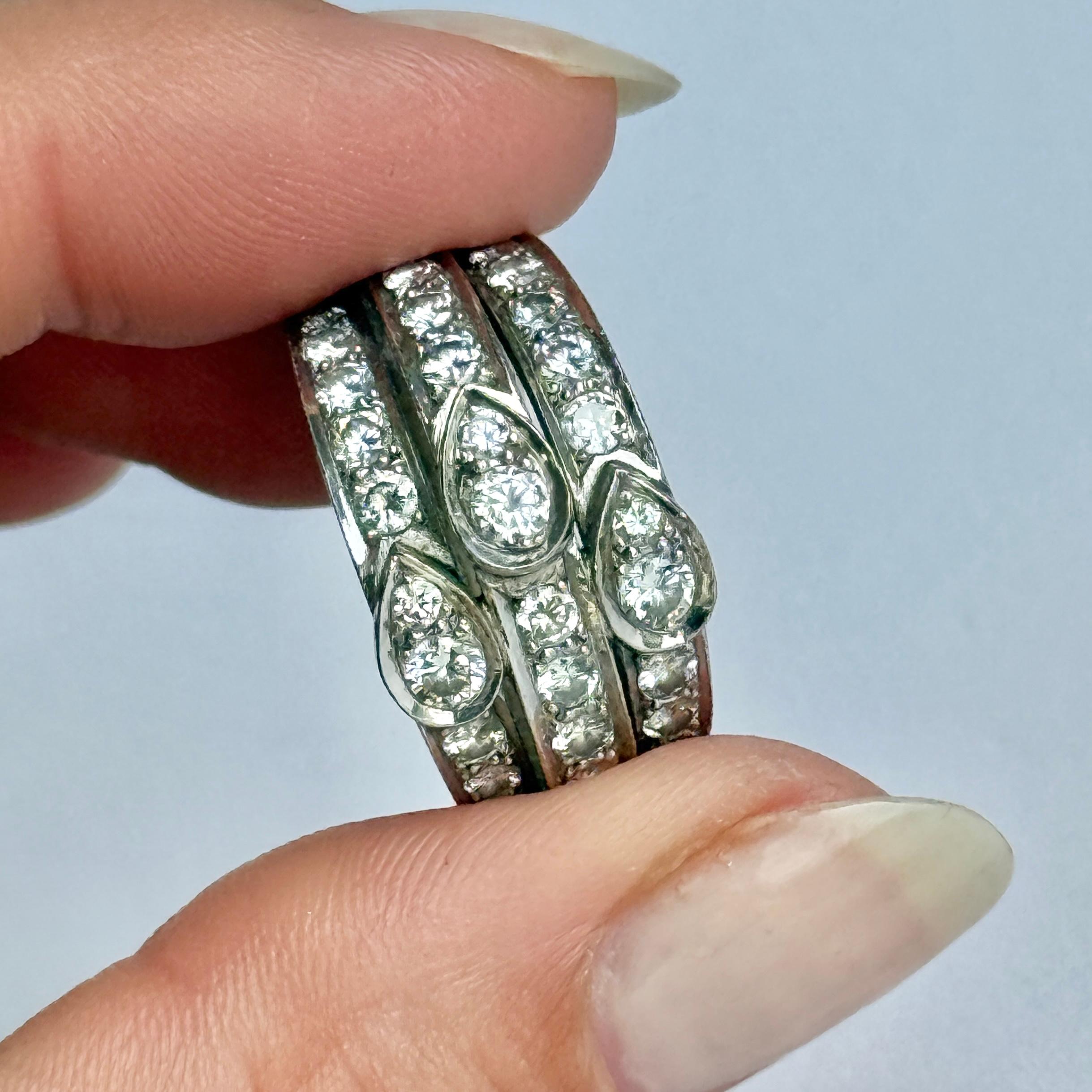 This spectacular vintage half eternity band is set with three rows of stunning round brilliant cut white diamonds. Modelled in 18 carat white gold. Diamond total approx 1.40 carats. 

Ring Size: L 1/2 or 6
Band Width: 12mm
Height Off Finger: