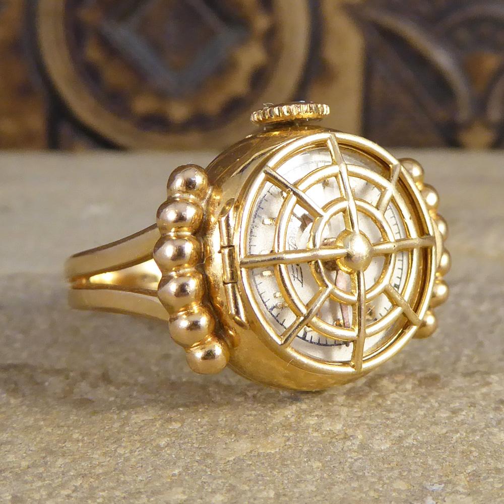 Such a gorgeous vintage piece which has been hand crafted from 18ct Yellow Gold. This ring is beautiful as a stand alone ring with 6 gold balls on each side of the face as a frame, and opening up to reveal a clock, working as two pieces in one. Such