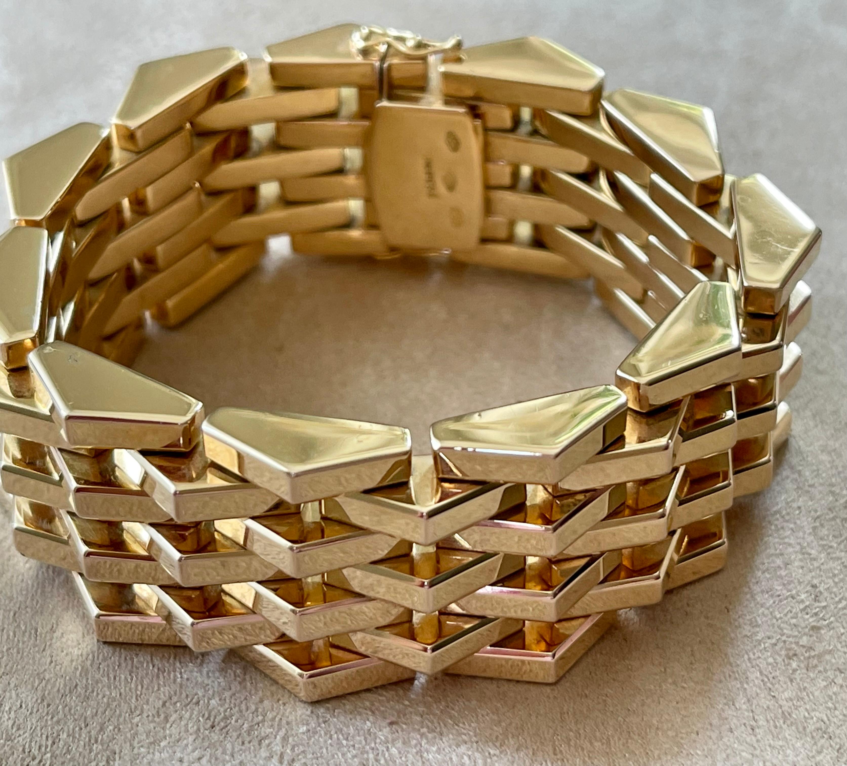 This splendid six row tank style bracelet is composed of large articulated geometric motifs each domed on the front. The clasp of this antique gold bracelet is a ratchet with a safety 8 feature.
Length: 17.5 cm, Width at widest point: 2.3 cm,