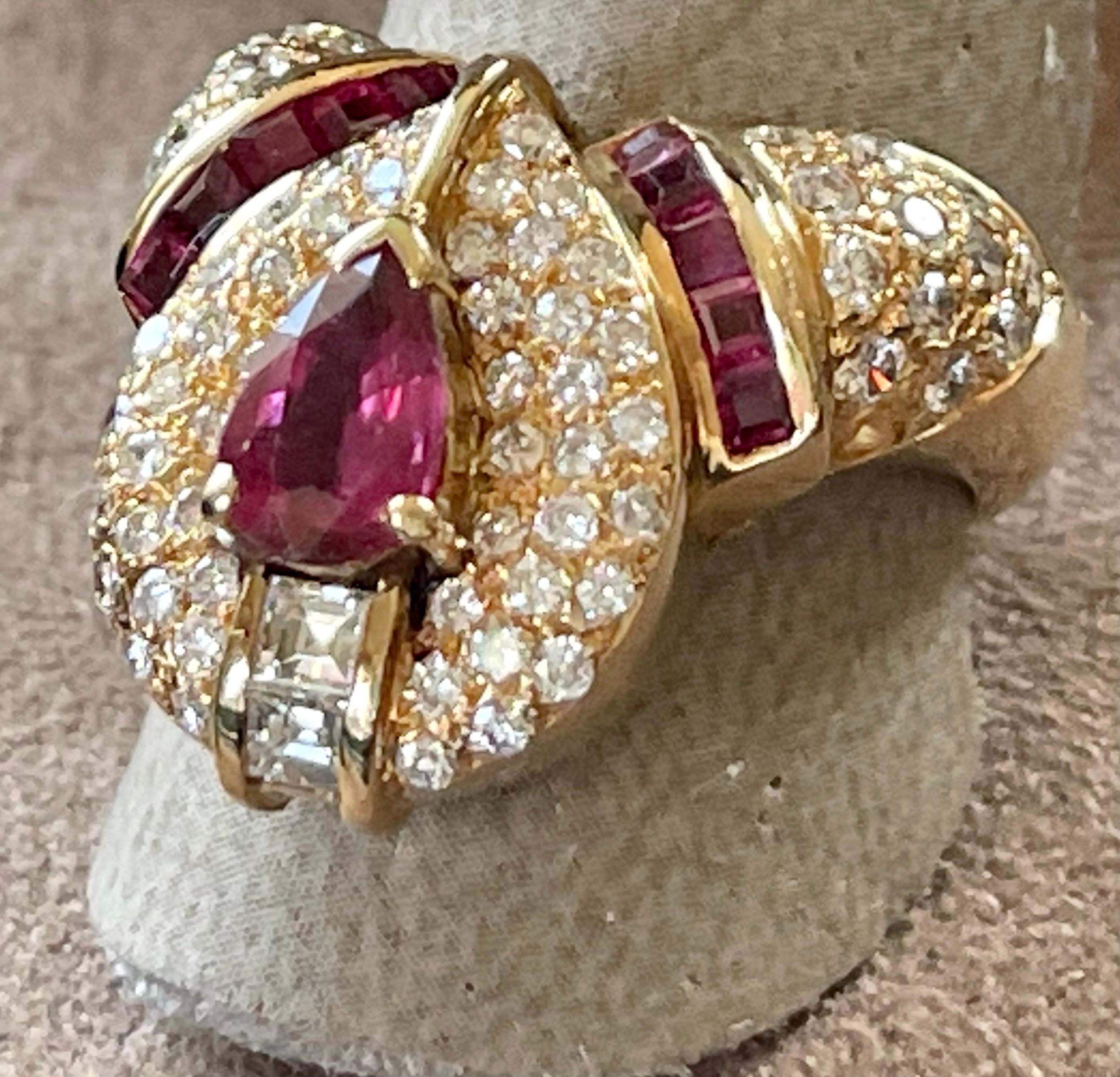 A pear shape shape ruby is the focal point of this retro ring. An oblong halo of pave set diamonds surround the center ruby, creating a elegant marquise shape. The shank is adorned by 1 row of channel set square cut Rubies and pavé set brilliant cut