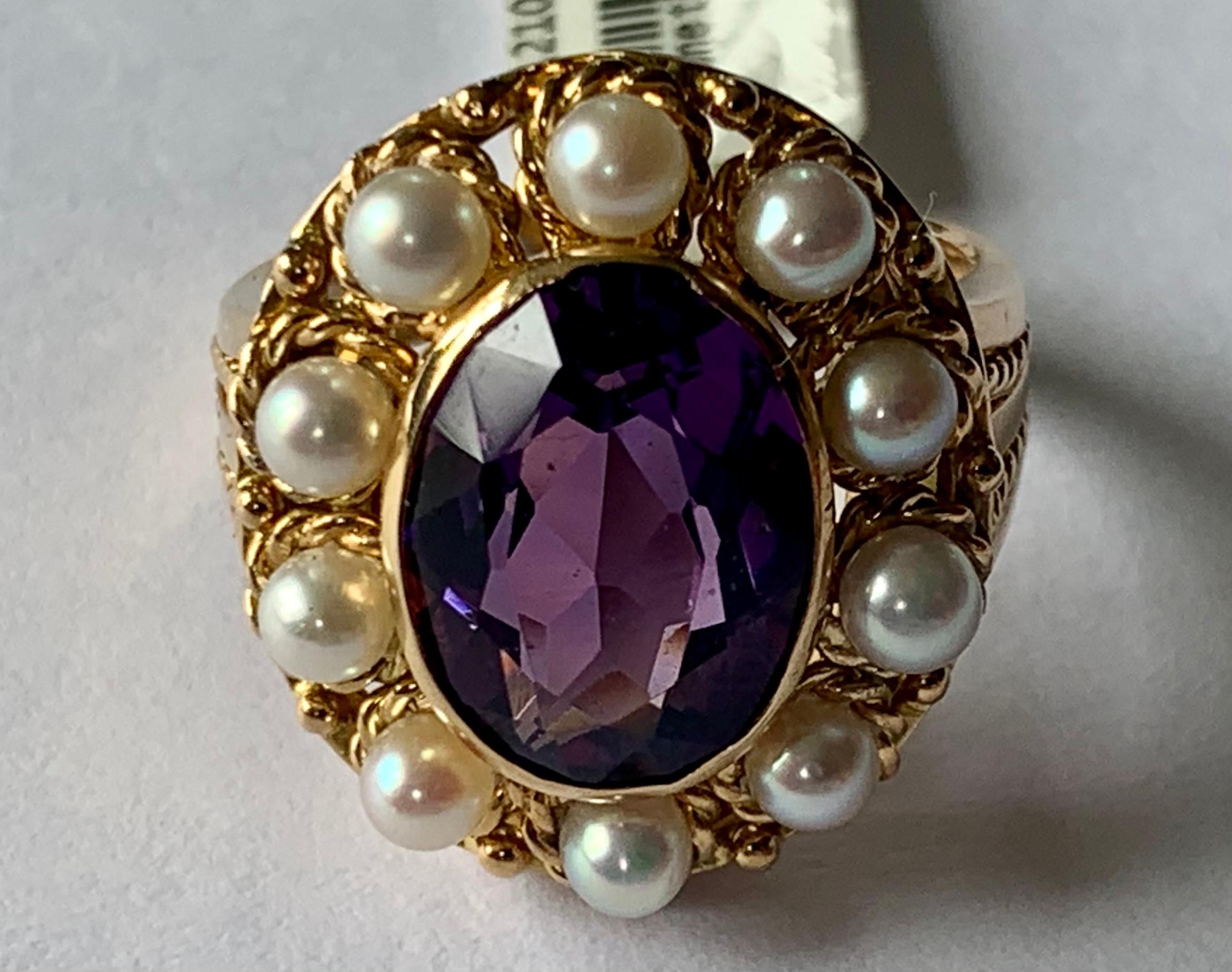 Romantic Vintage Ring in 18 K yellow Gold inspired by the Victorian era featuring an oval cut Amethyst and cultured pearls in a rope textured setting. 
The ring is currently size 13/53 but can be resized easily. 
Matching pendant/brooch