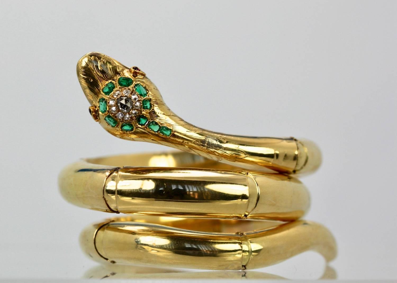 This bracelet comes from France and is vintage circa 1940.  It is made of 18K Yellow Gold and has an old .40 carat Diamond center and old cut Diamonds 1 point each Diamond surround 10 stones, 2 small Ruby eyes, 10 Emeralds various sizes and etched