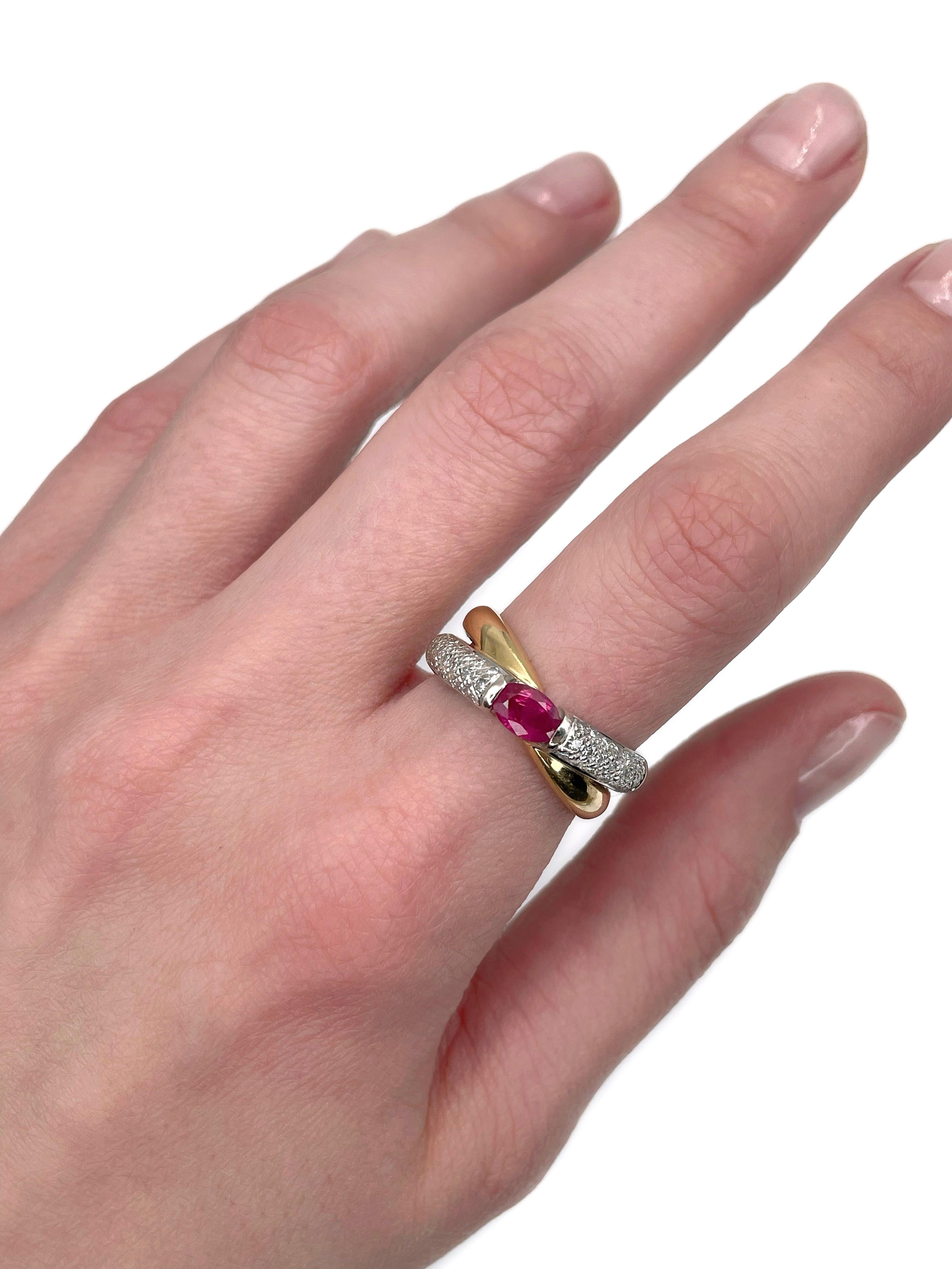 This is a vintage crossover band ring crafted in 18K gold. Circa 1970. 

It features:
- 1 ruby (oval cut, 0.60ct, slpR 6/4, SI)
- 42 diamonds (round brilliant cut, TW 0.21ct, RW-W, VS-SI)

Weight: 7.15g
Size: 17.75 (US 7.5)

IMPORTANT: please ask