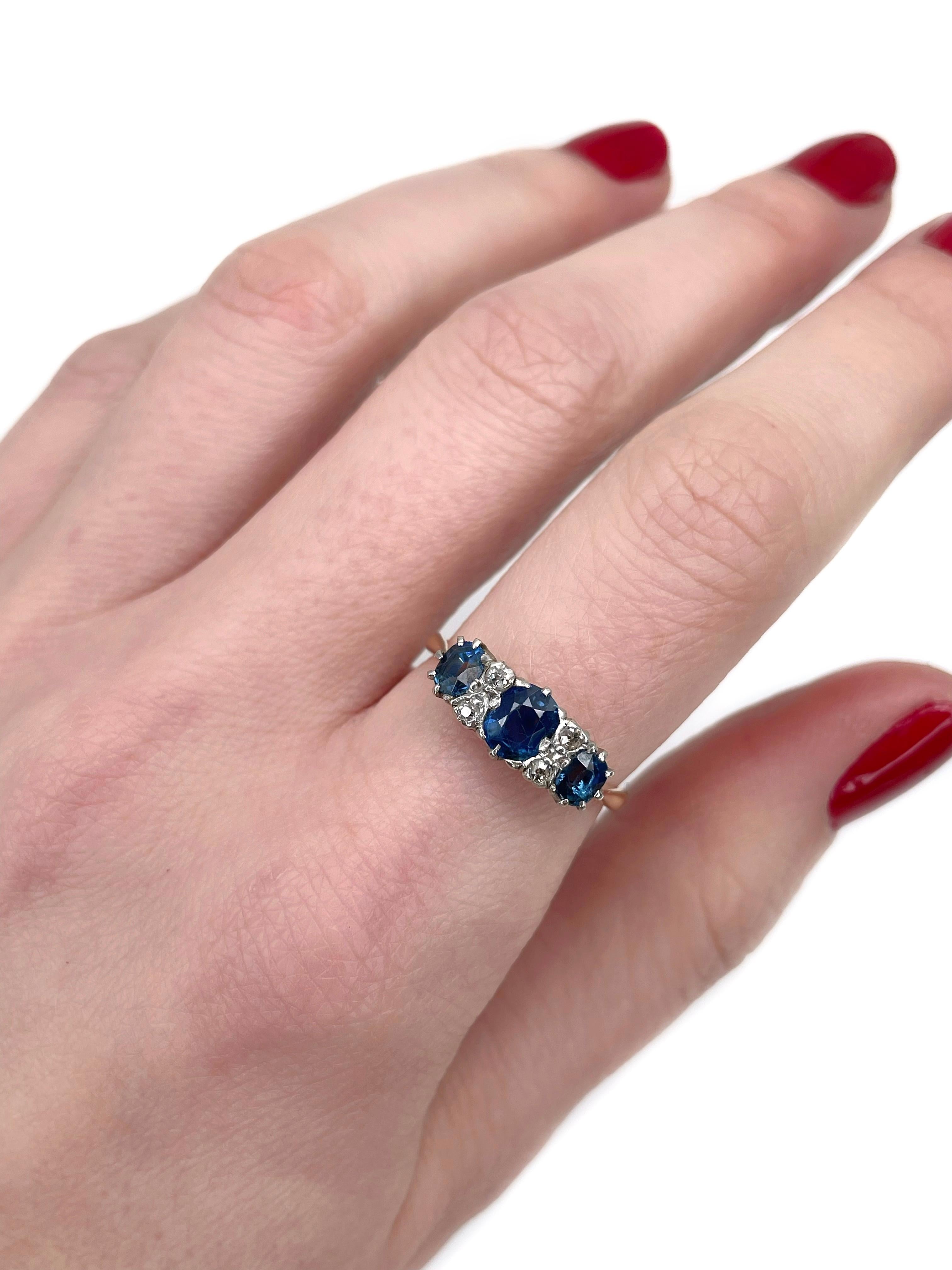 This is a vintage three-stone ring crafted in 18K yellow gold and 950 platinum. Circa 1960. 

The piece features:
- 3 sapphires (oval cut, TW 1.10ct, B 6/3, VS-SI)
- 4 diamonds (old cut, TW 0.11ct, W-STW, SI)

Weight: 3.08g
Size: 17.5 (US