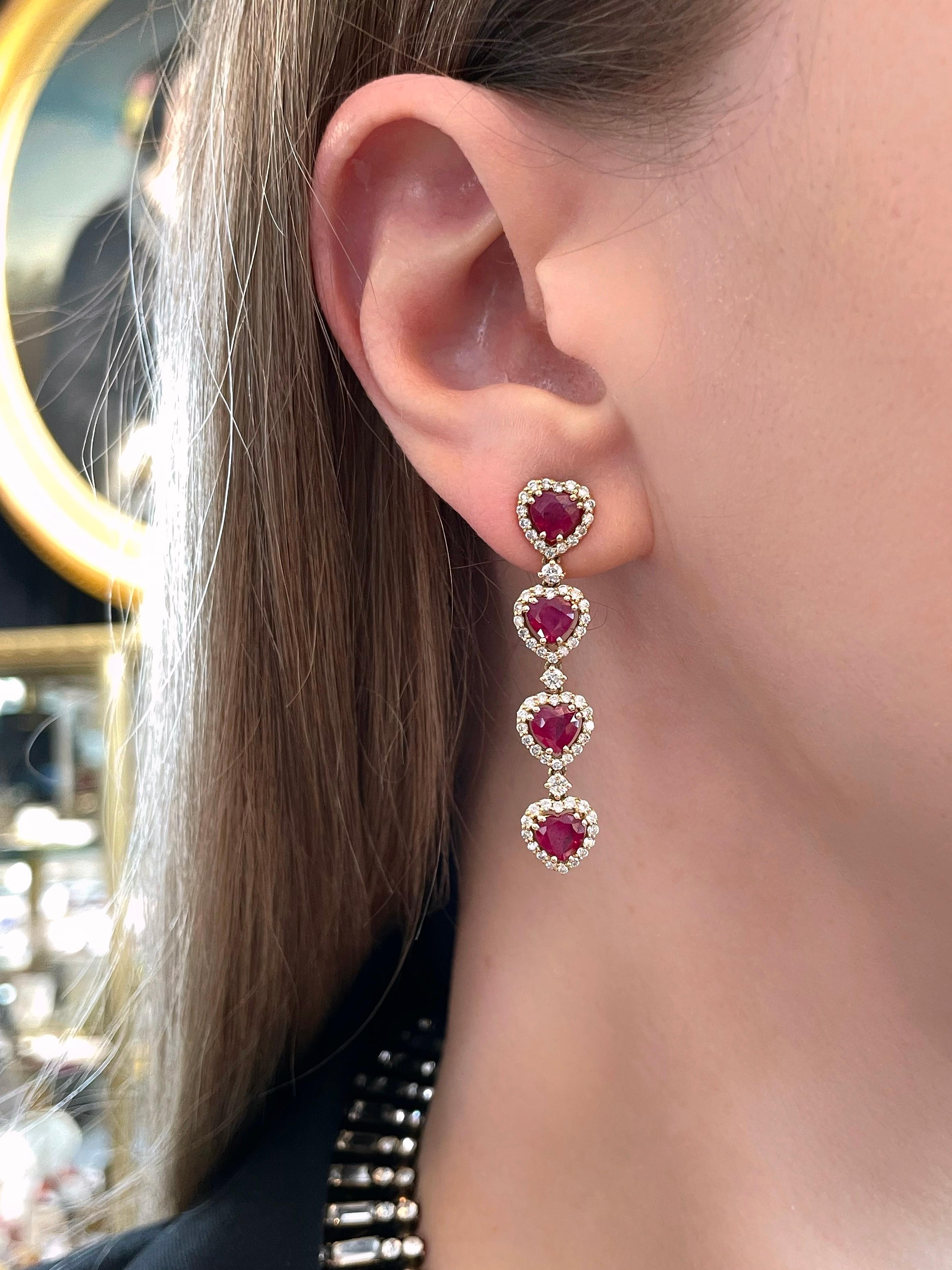 This is a pair of vintage heart drop stud earrings. It is crafted in 18K yellow gold. Circa 1980.

The piece features:
- 8 rubies, heart cut, TW 4.70ct, slpR 7/4, P1
- 70 diamonds, round brilliant cut, TW 0.75ct, RW-W, VS-SI

Weight: 7.13g
Length: