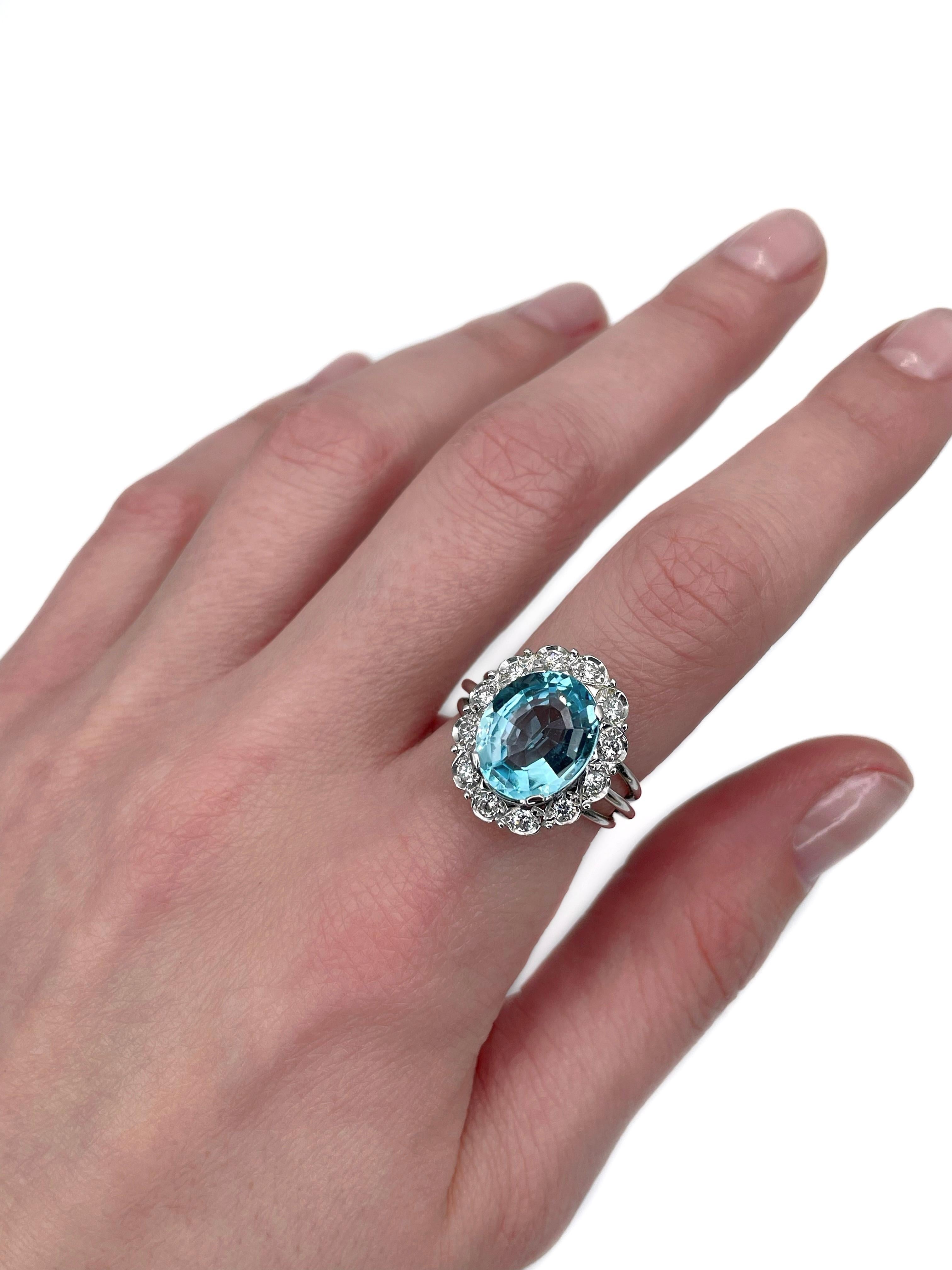 This is a vintage cluster ring crafted in 18K white gold. Circa 1980. 

The piece features:
- 1 topaz (oval cut, 5.50ct, gB 4/2, VVS)
- 12 diamonds (round brilliant cut, TW 0.50ct, RW-W, VS-SI)

Weight: 6.50g
Size: 17 (US 6.75)

IMPORTANT: please