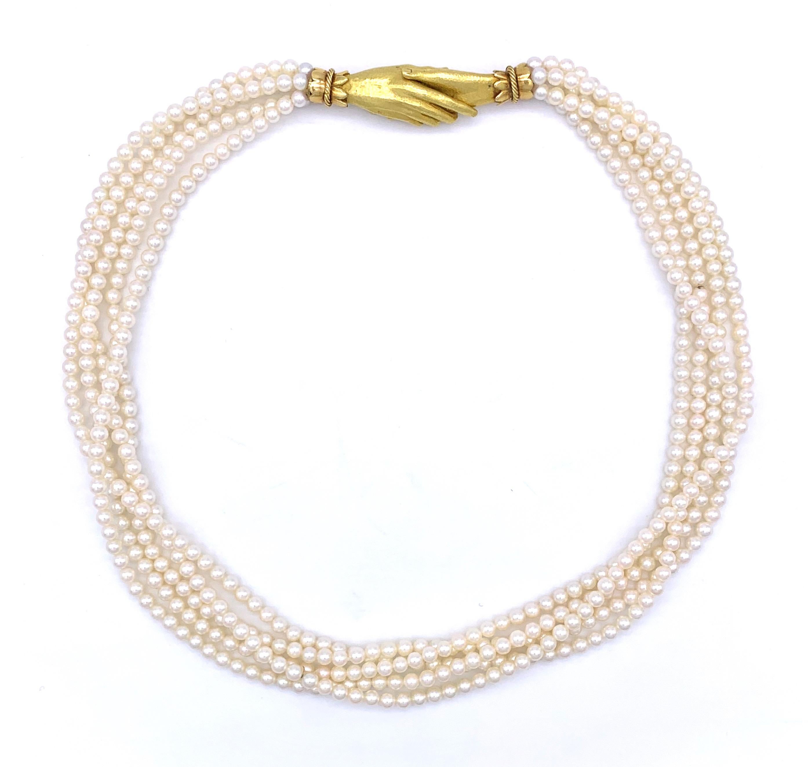 Two finely modelled joined hands double as a clasp and make this five strand Akoya cultered pearl necklace a truly sentimental gift, a token of friendship and love. Five rows of the finest, completely round and beautifully matched pearls make up