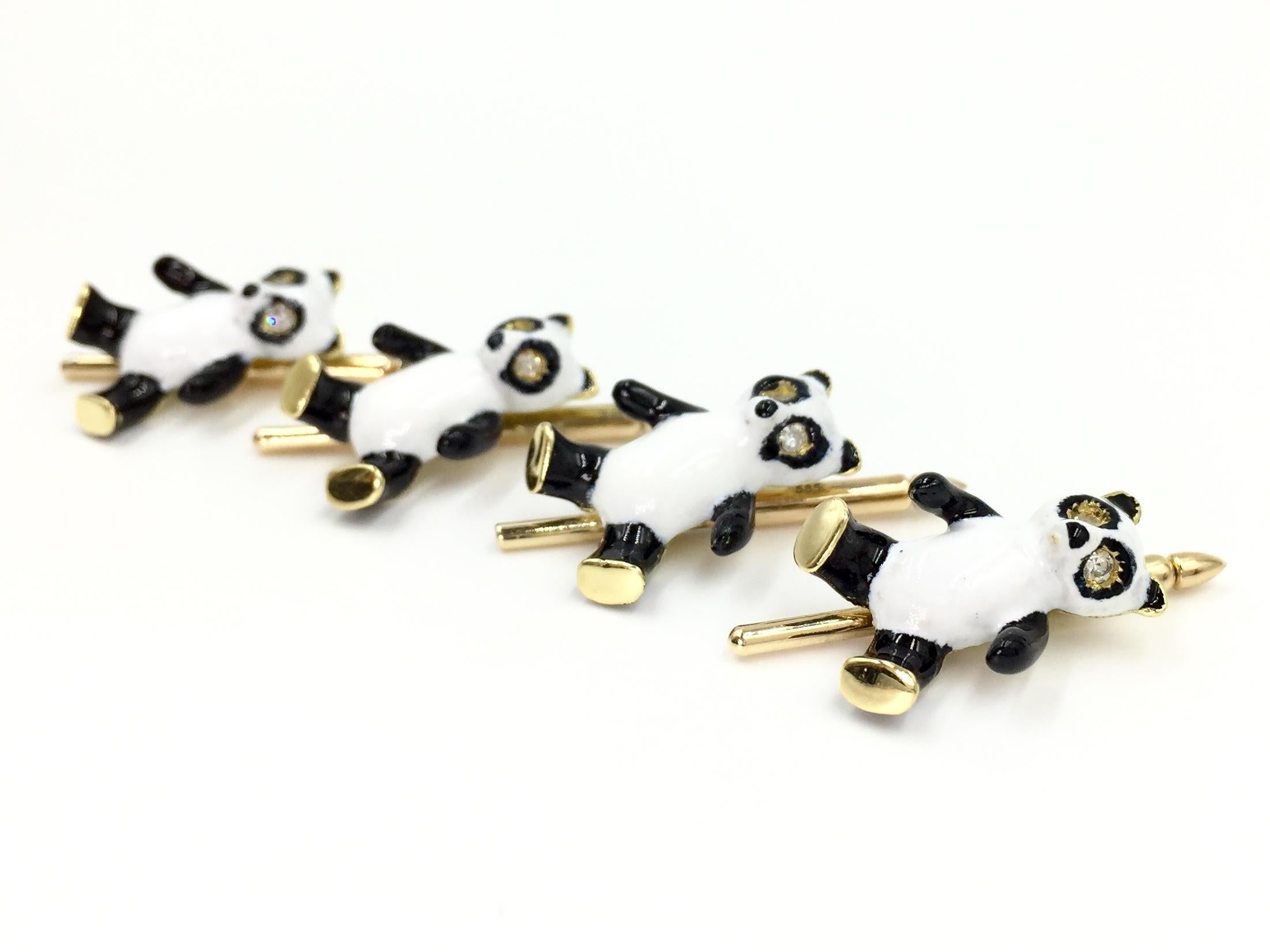 Circa 1978. A truly unique find for a vintage cuff link and shirt stud collector. These fun 18 karat yellow gold panda vintage shirt studs feature black and white hand painted enamel with round diamond eyes. Set of four.
Each panda has a length of