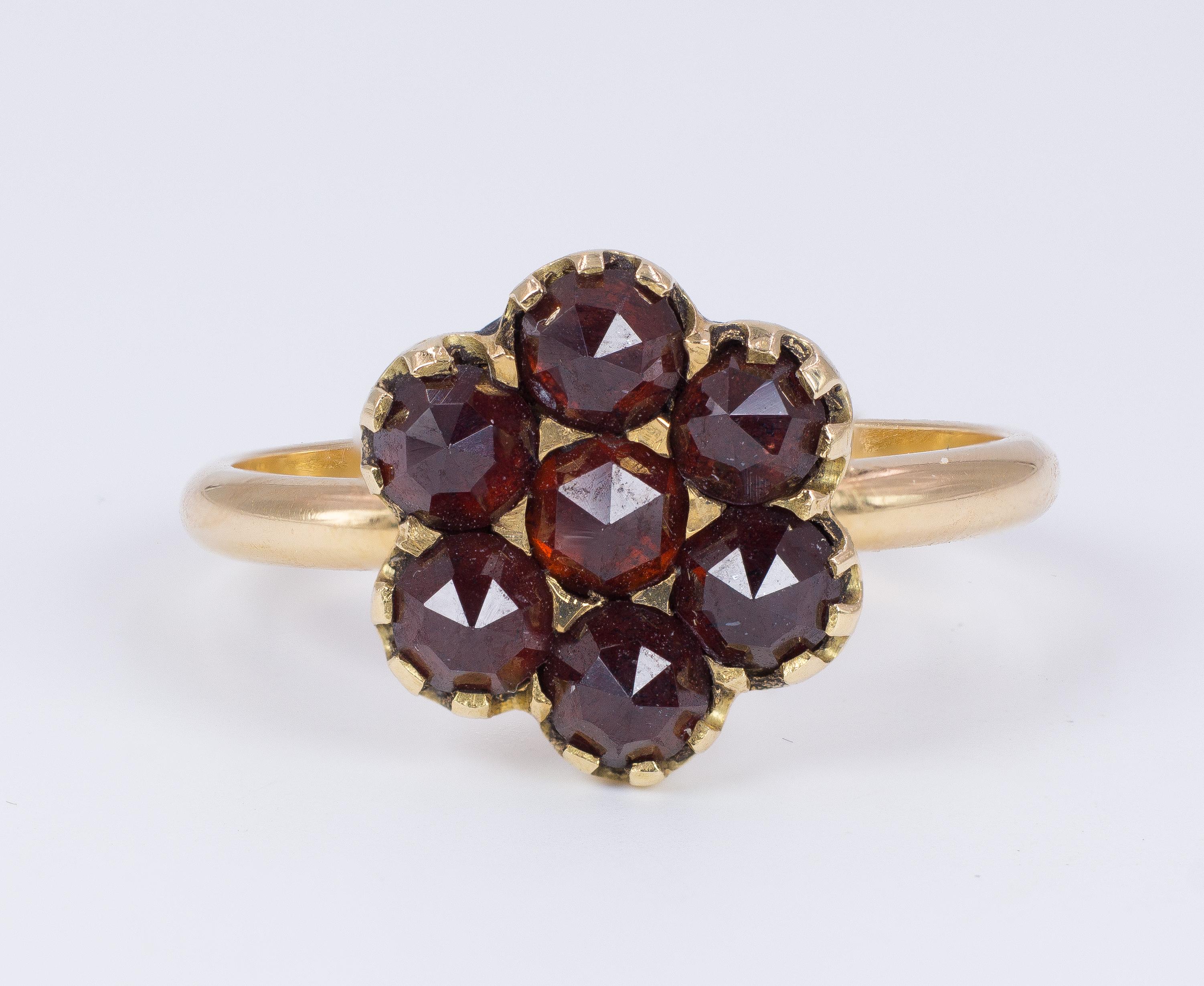 This fine but elegant vintage ring, dating from the 1950s, features a lovely flower shape, where the petals and the centre are six dark red garnets.
The ring is modelled in 18K gold throughout. 

MATERIALS
18K gold and garnets

RING SIZE
7 US