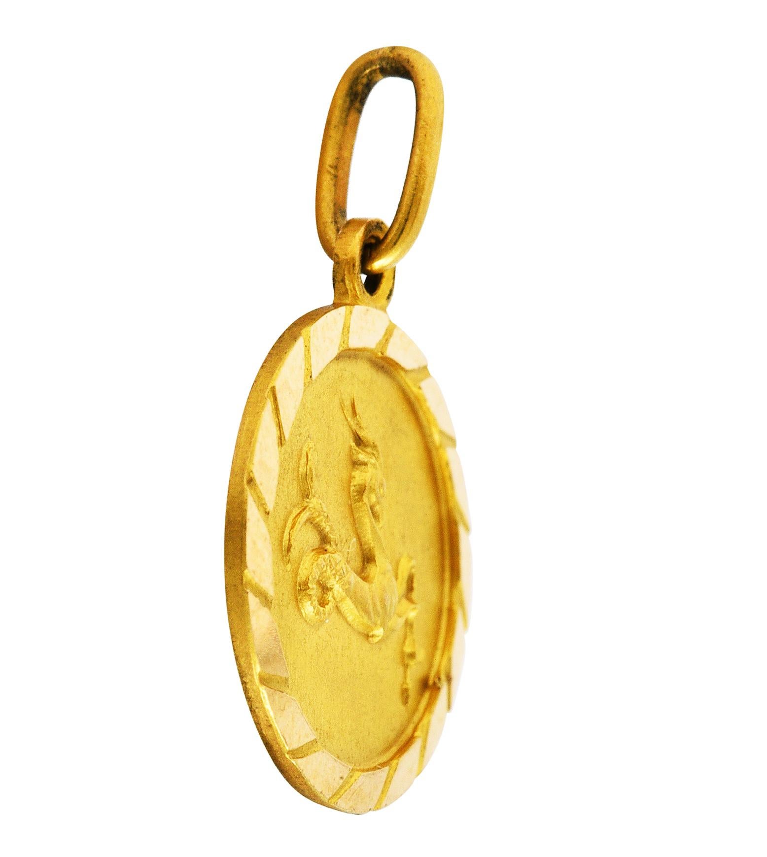 Circular charm has a matte finish and a raised rendering of Capricorn

Zodiac figure depicted as a sea goat with horned head and fish tail

Faceted high polished surround

Stamped 750 for 18 karat gold

Circa: 1970's

Measures: 1/2 x 3/4 inch
